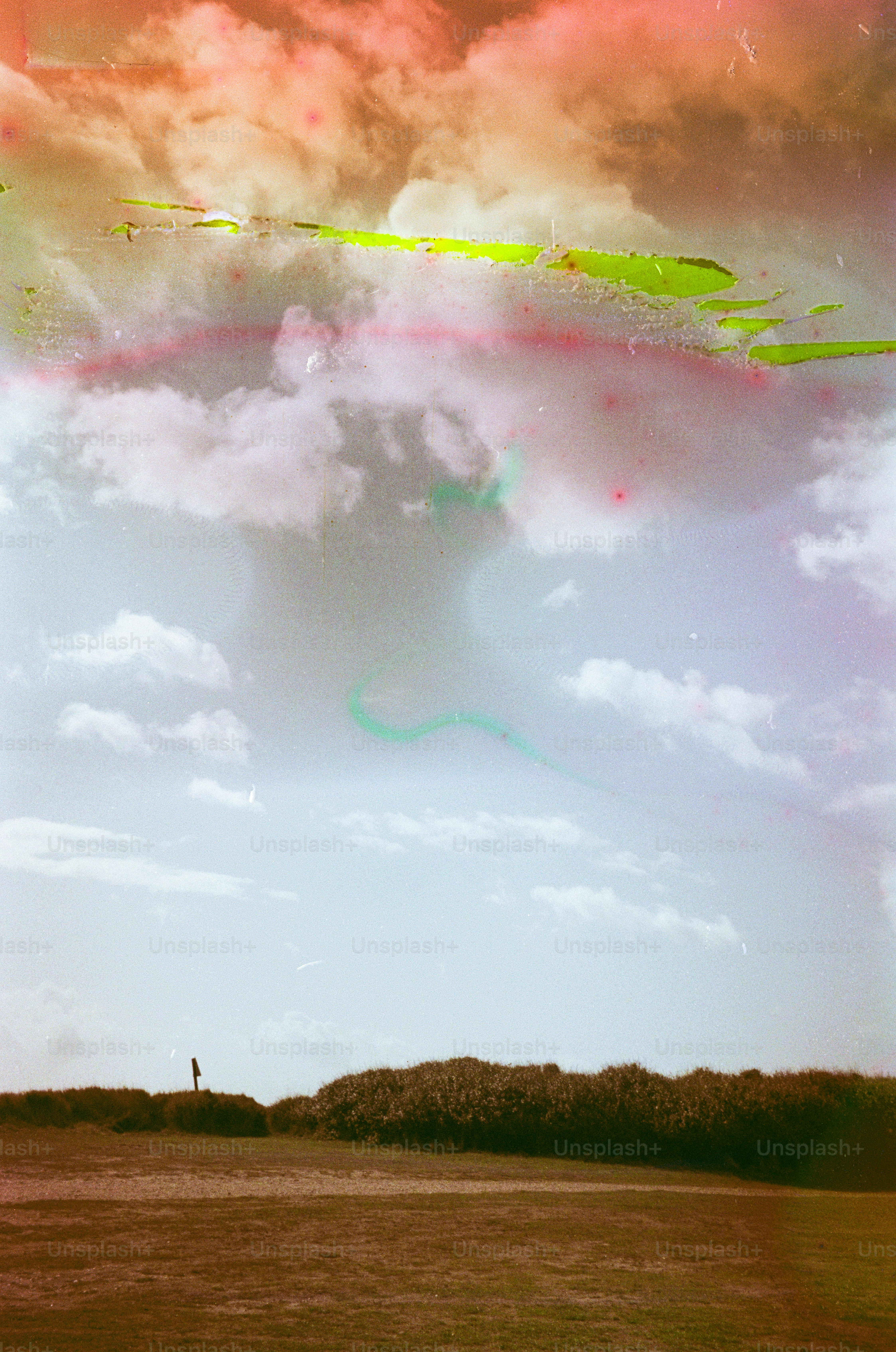 Person standing on grassy hill under cloudy sky