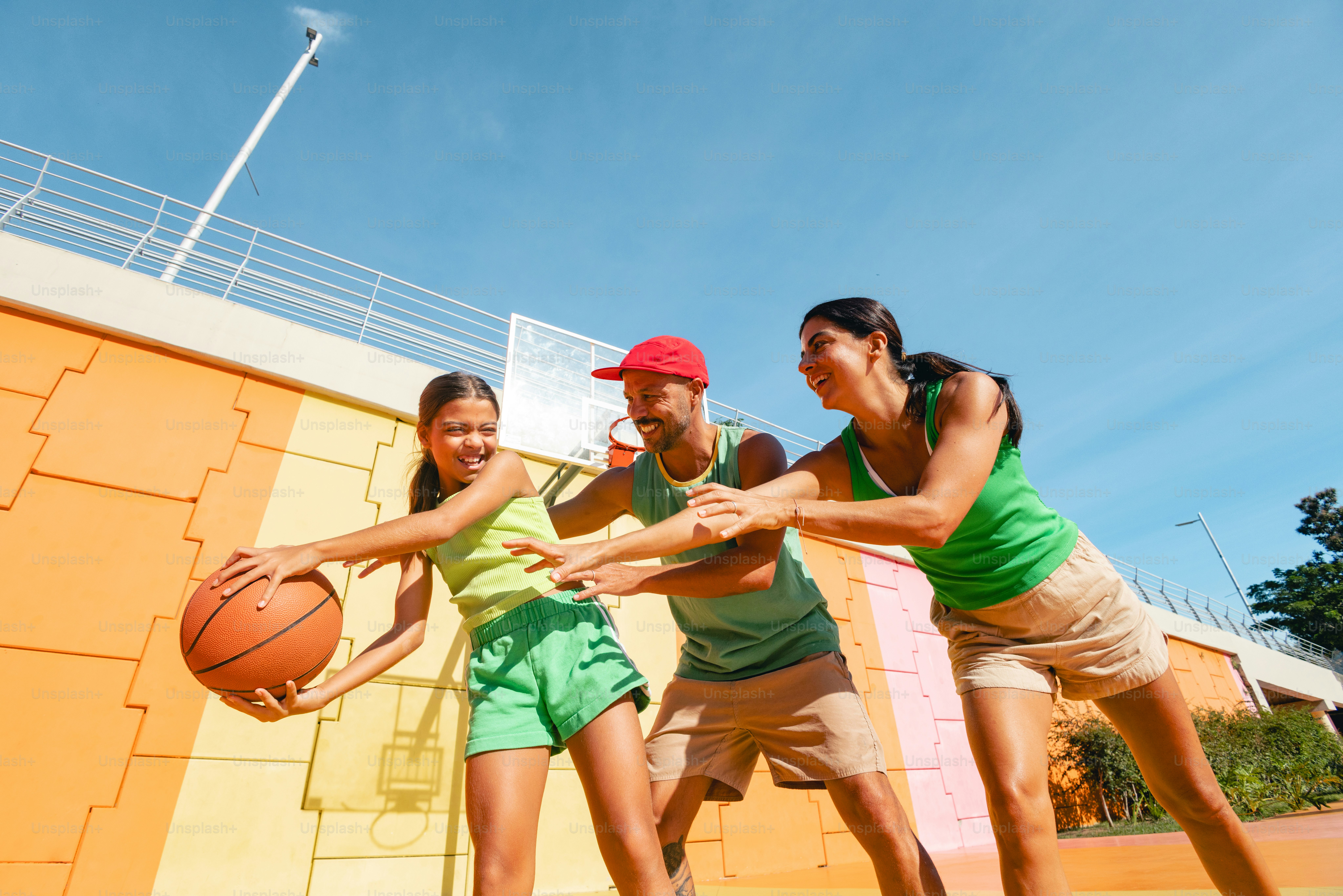 Family playing basketball together outdoors