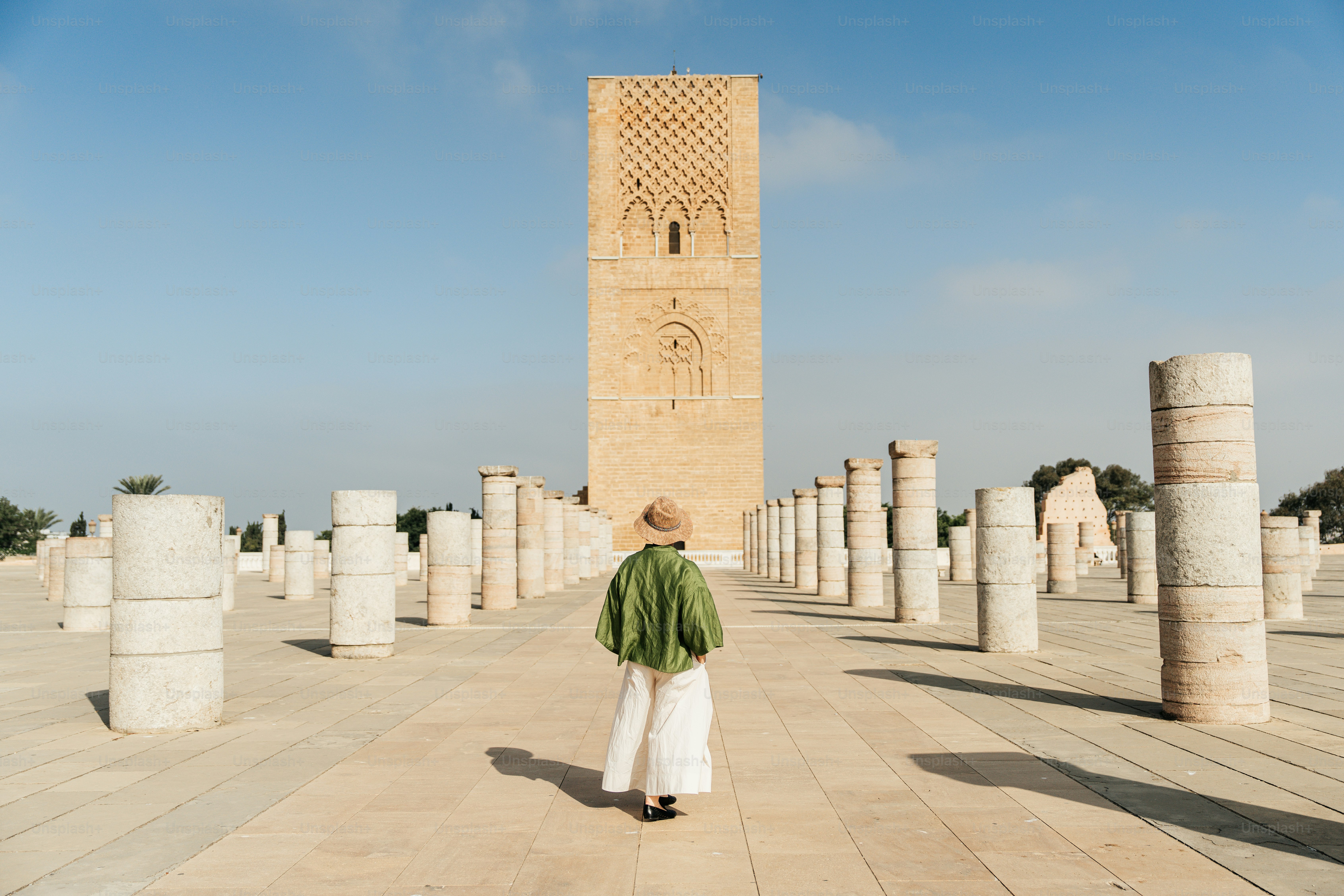 Woman walking towards hassan tower in rabat, morocco