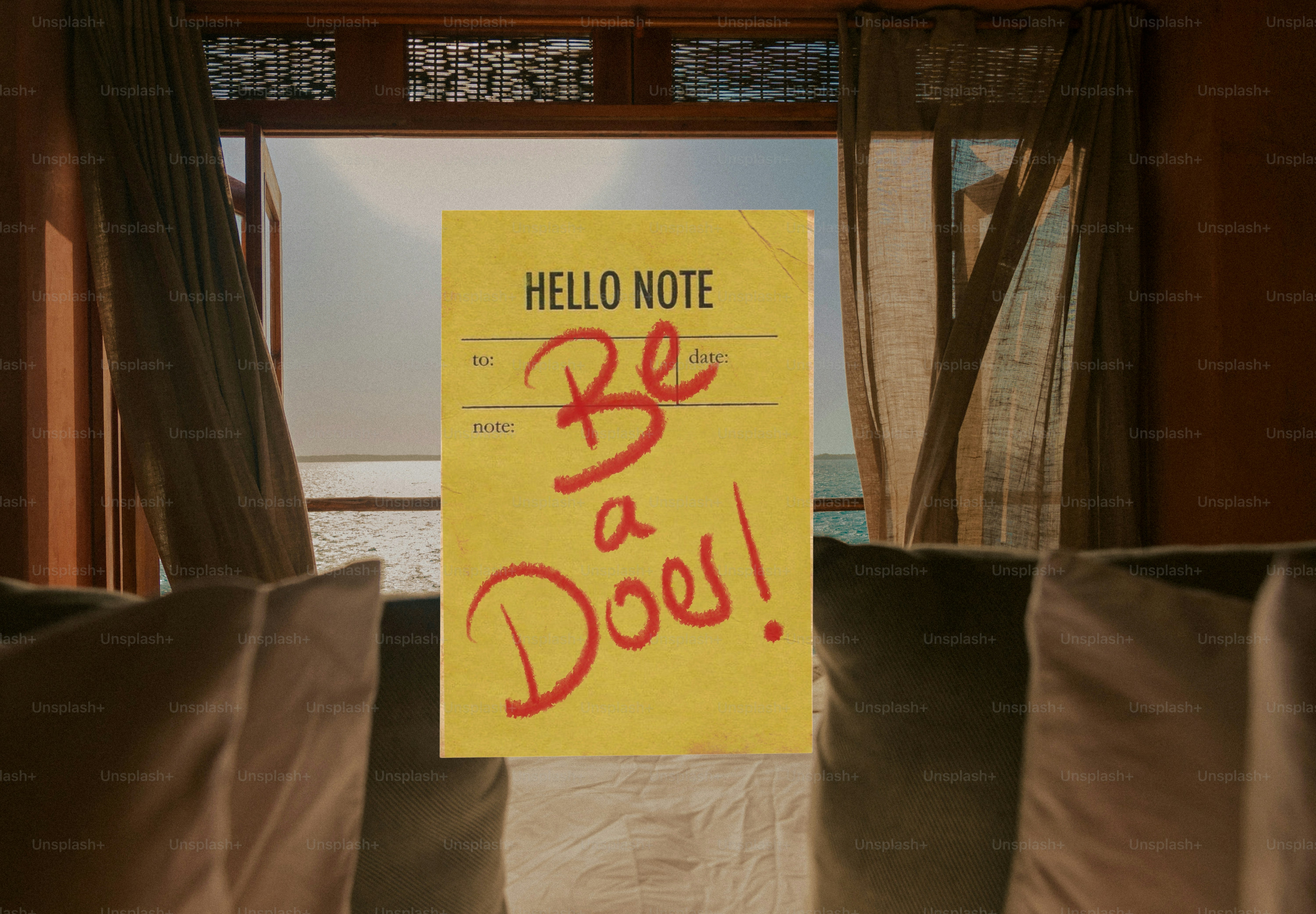 Yellow note with 'be a doer!' message on window.