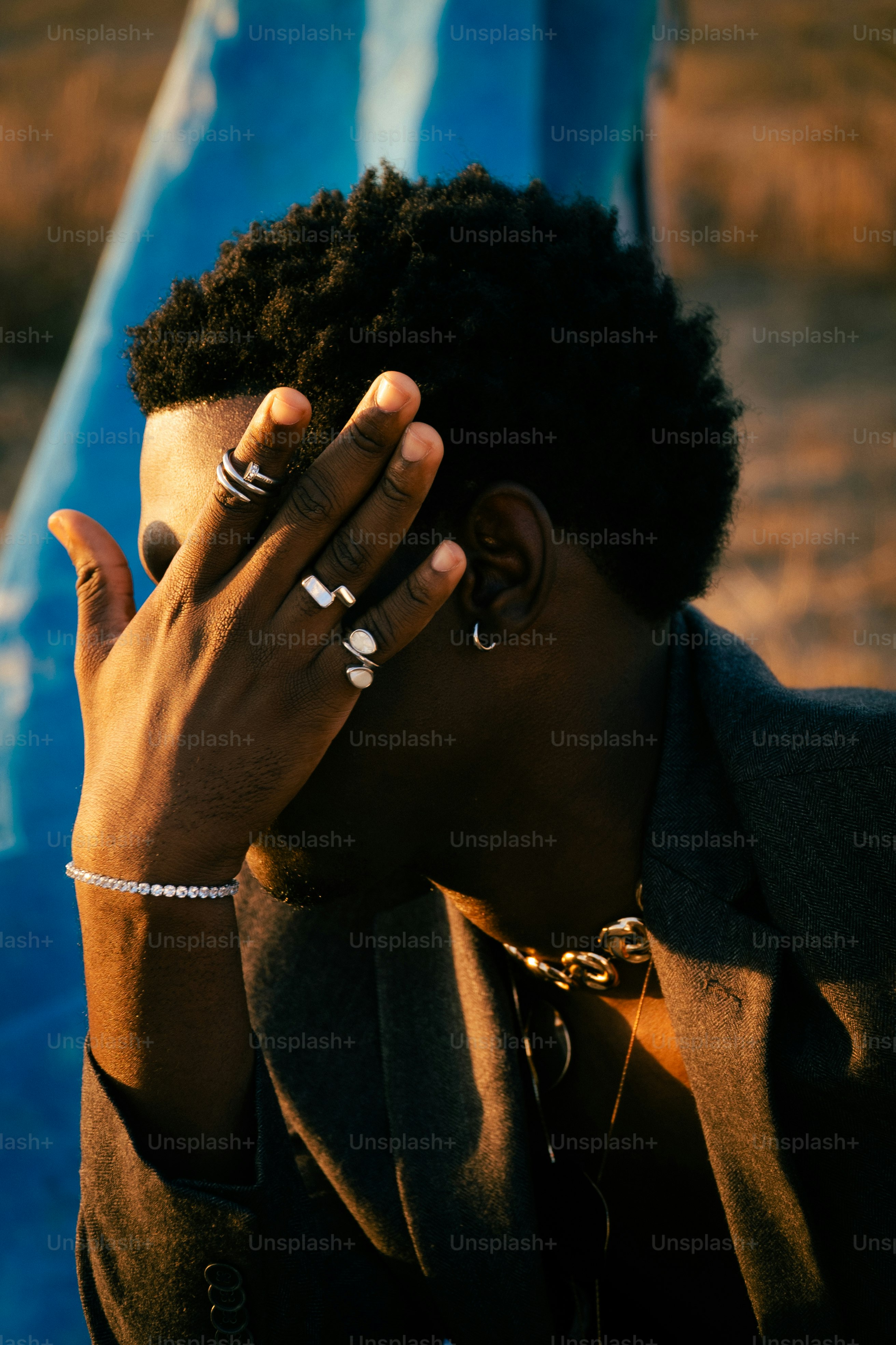 Hombre de traje que se cubre la cara con la mano.