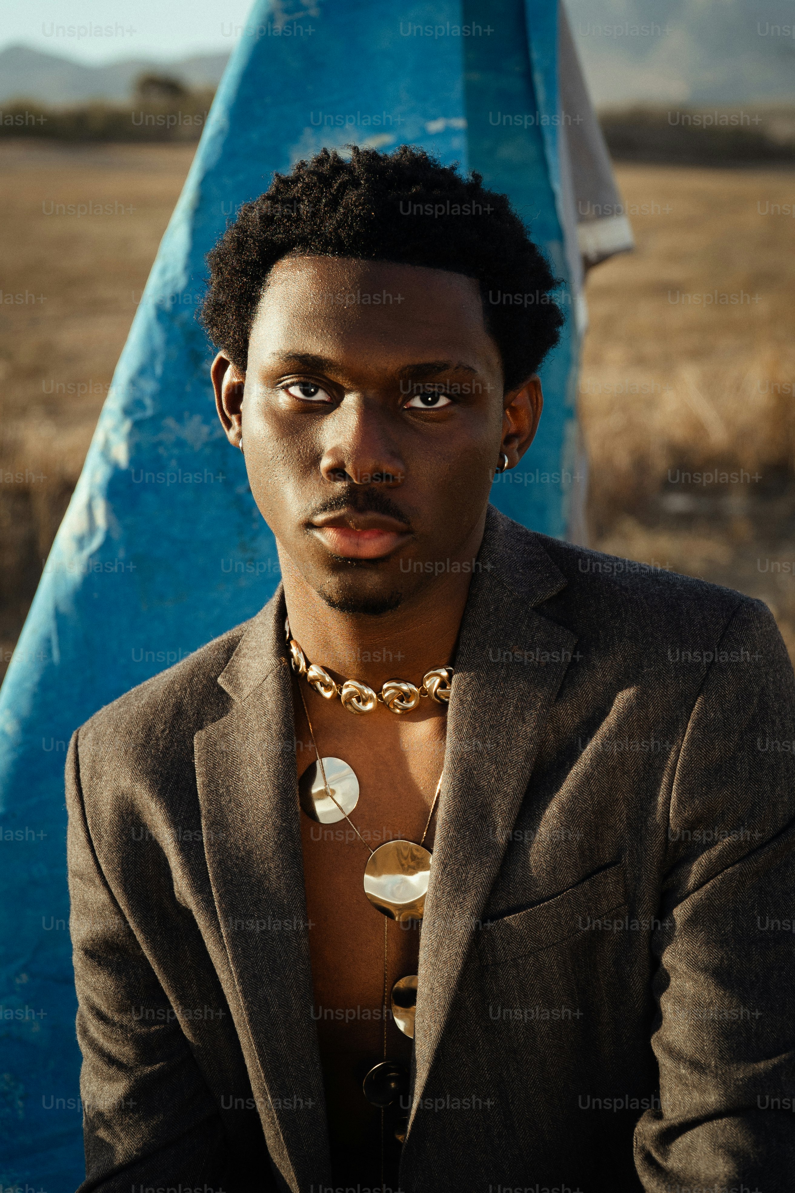 Hombre de traje con collar grande al aire libre