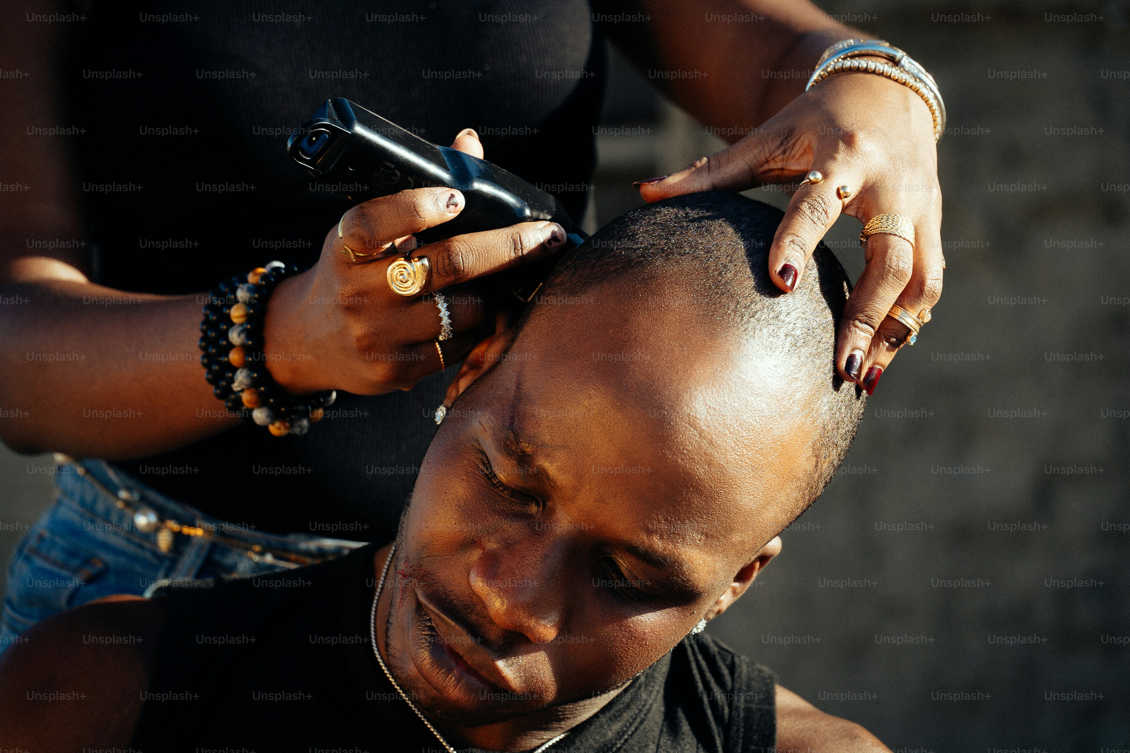 A person getting their head shaved with clippers.