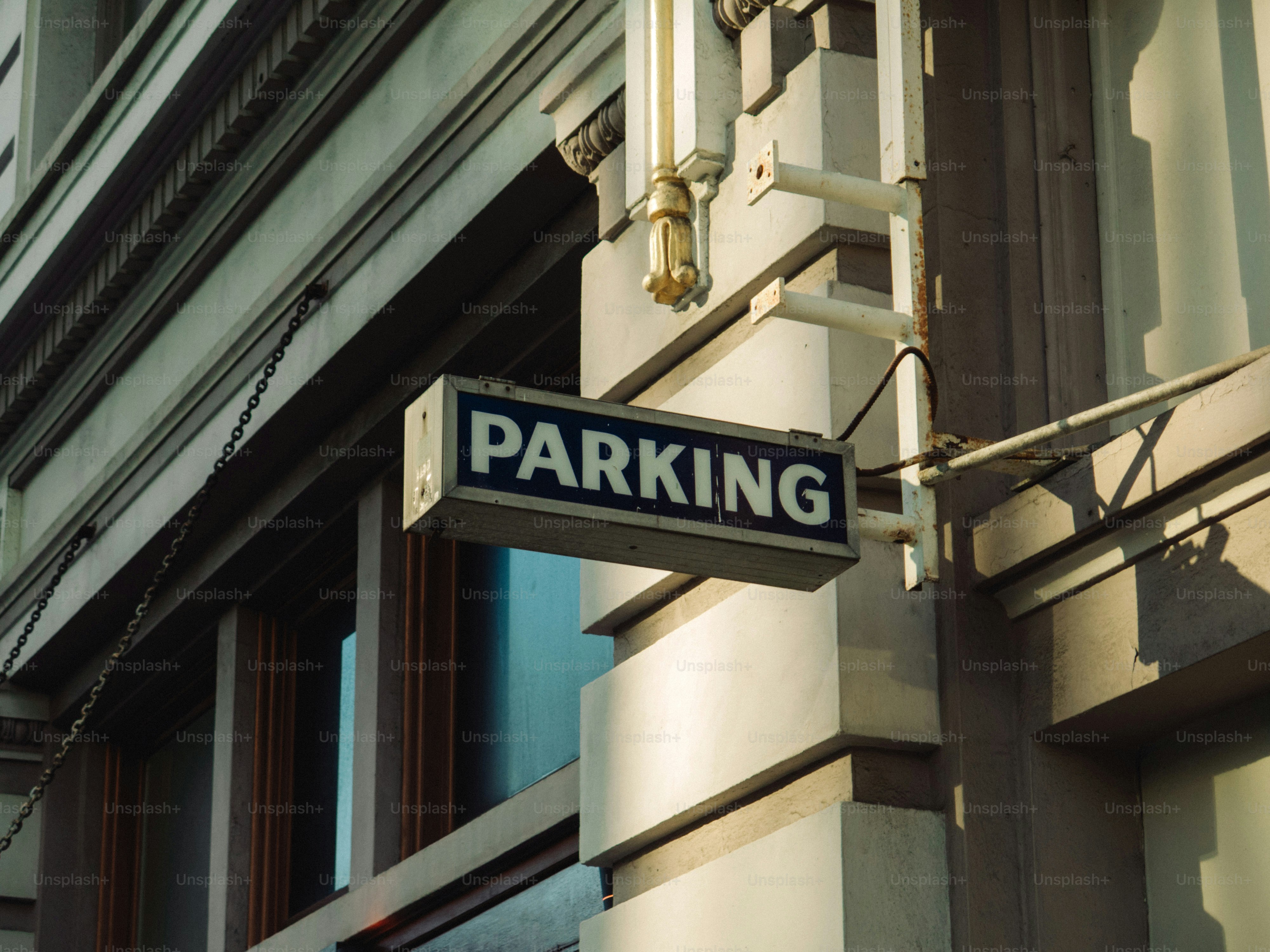A sign reads parking on a building.