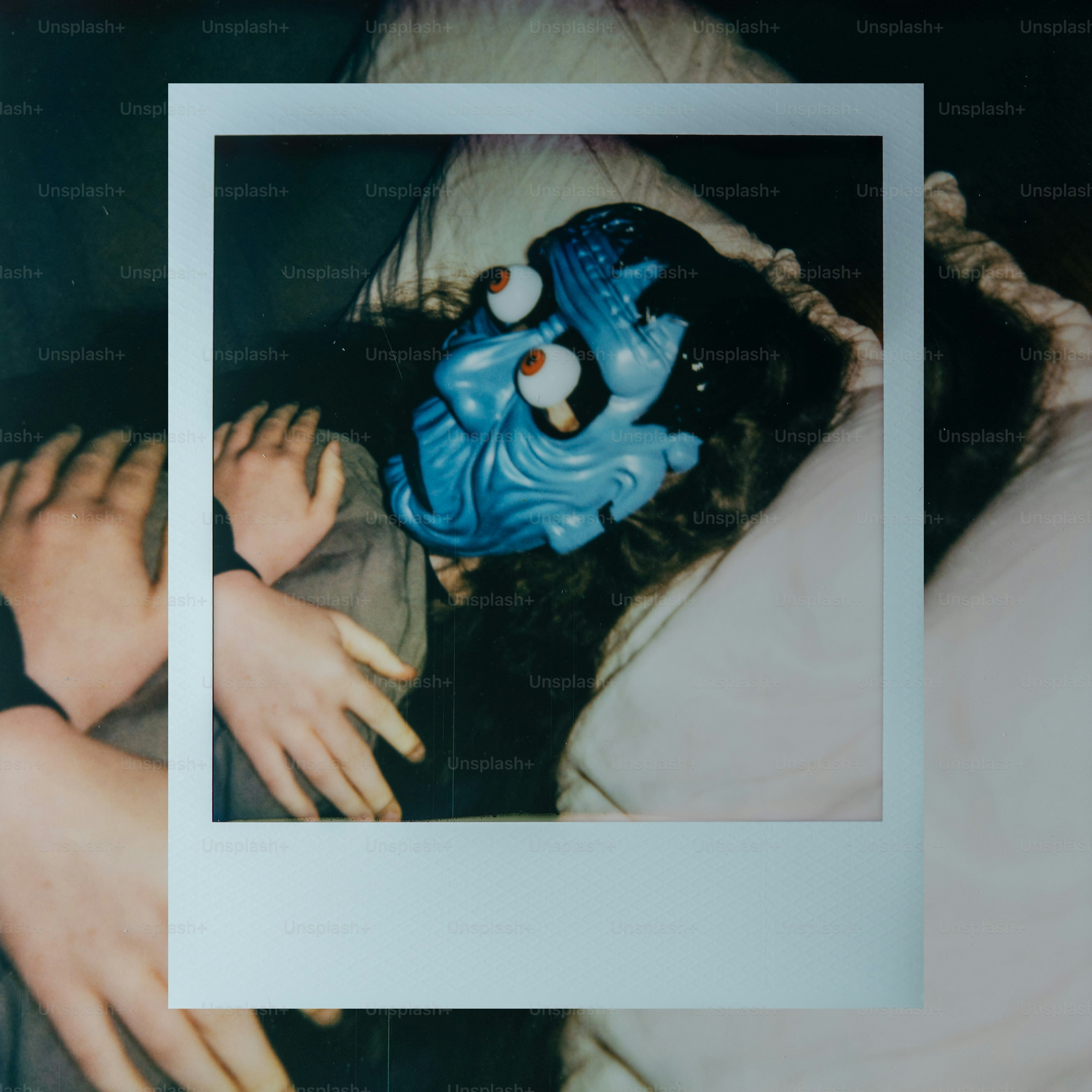 Person wearing a blue mask with wide eyes.