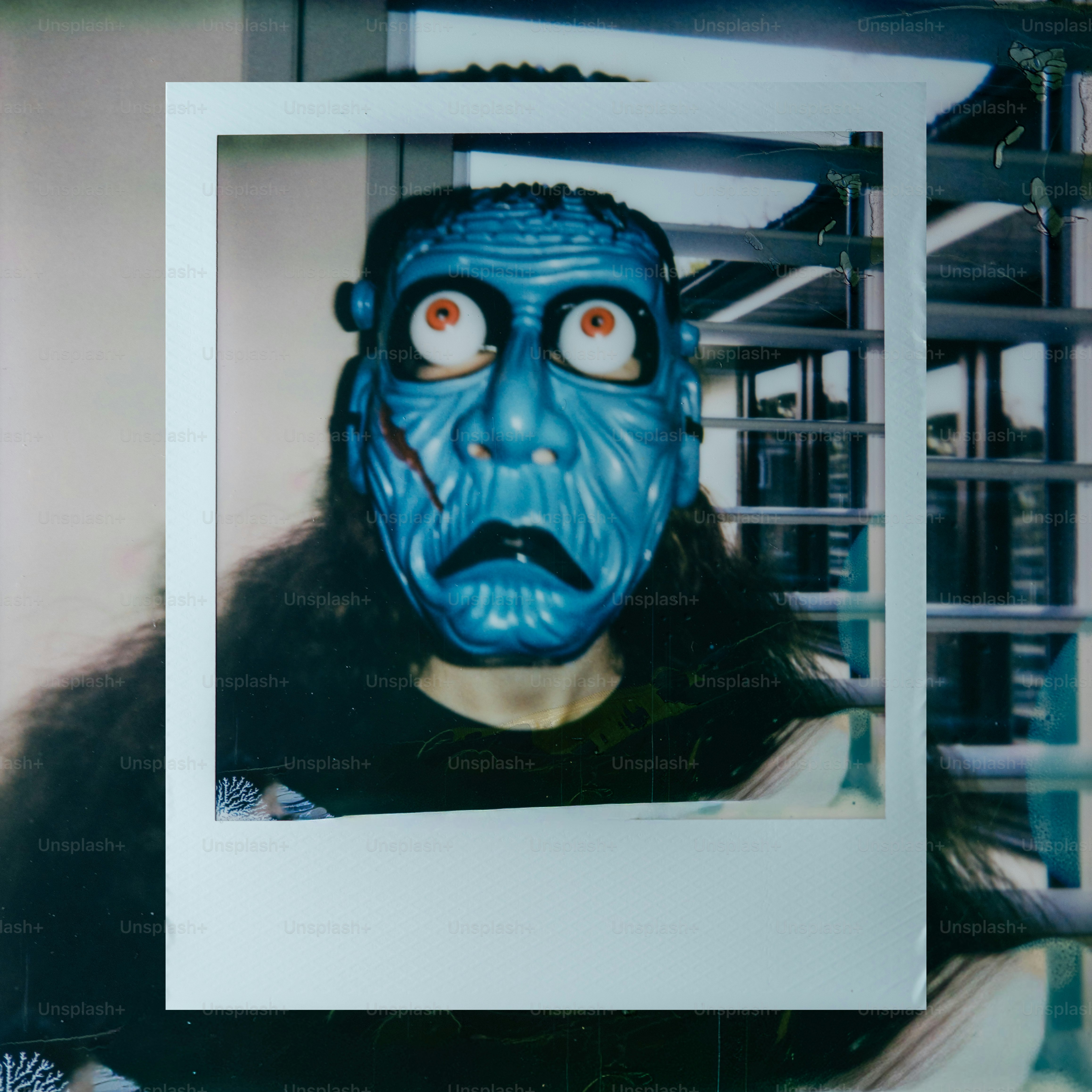 Person in a blue monster mask with wide eyes