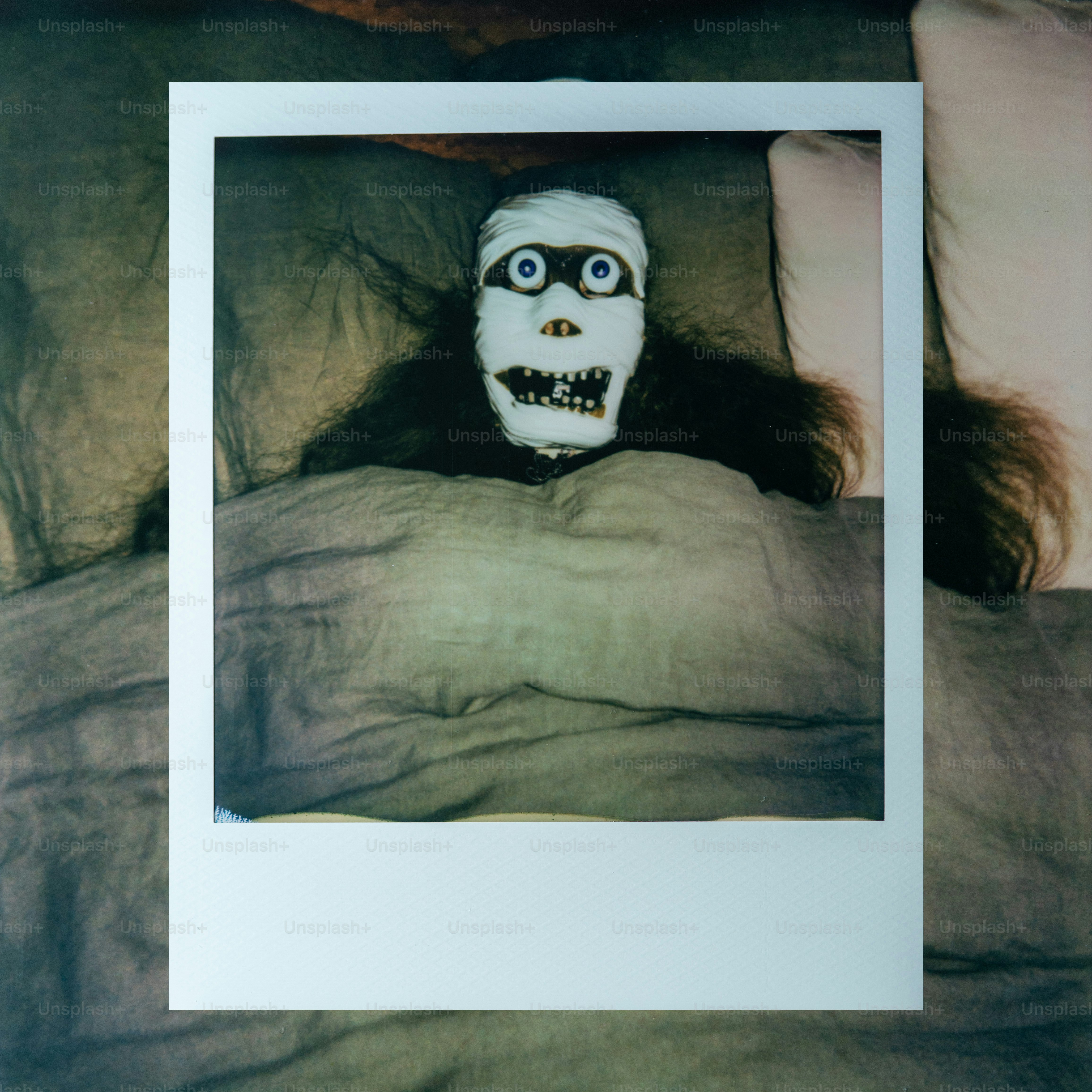A mummy doll lying in a bed