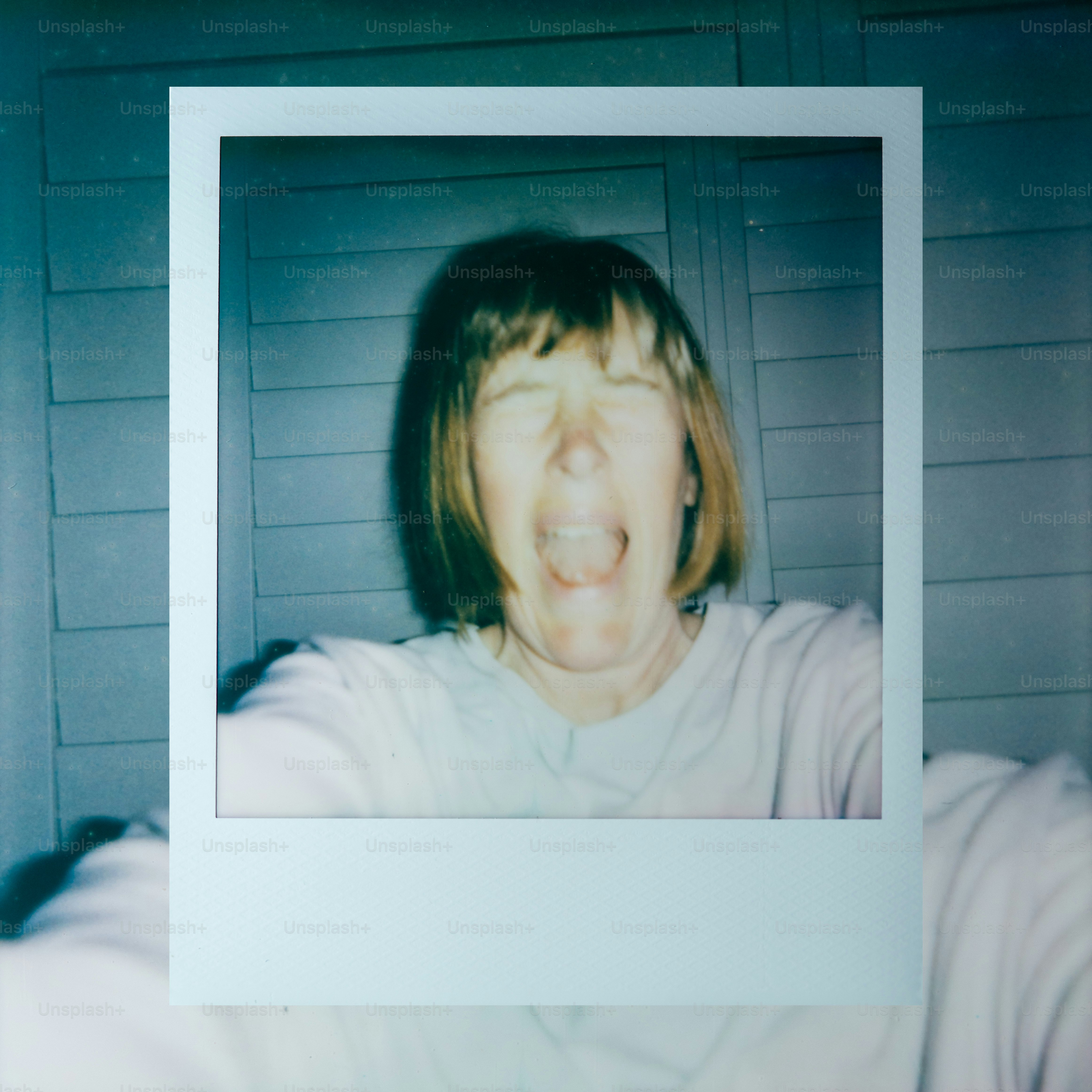 Woman screaming in a blurry polaroid