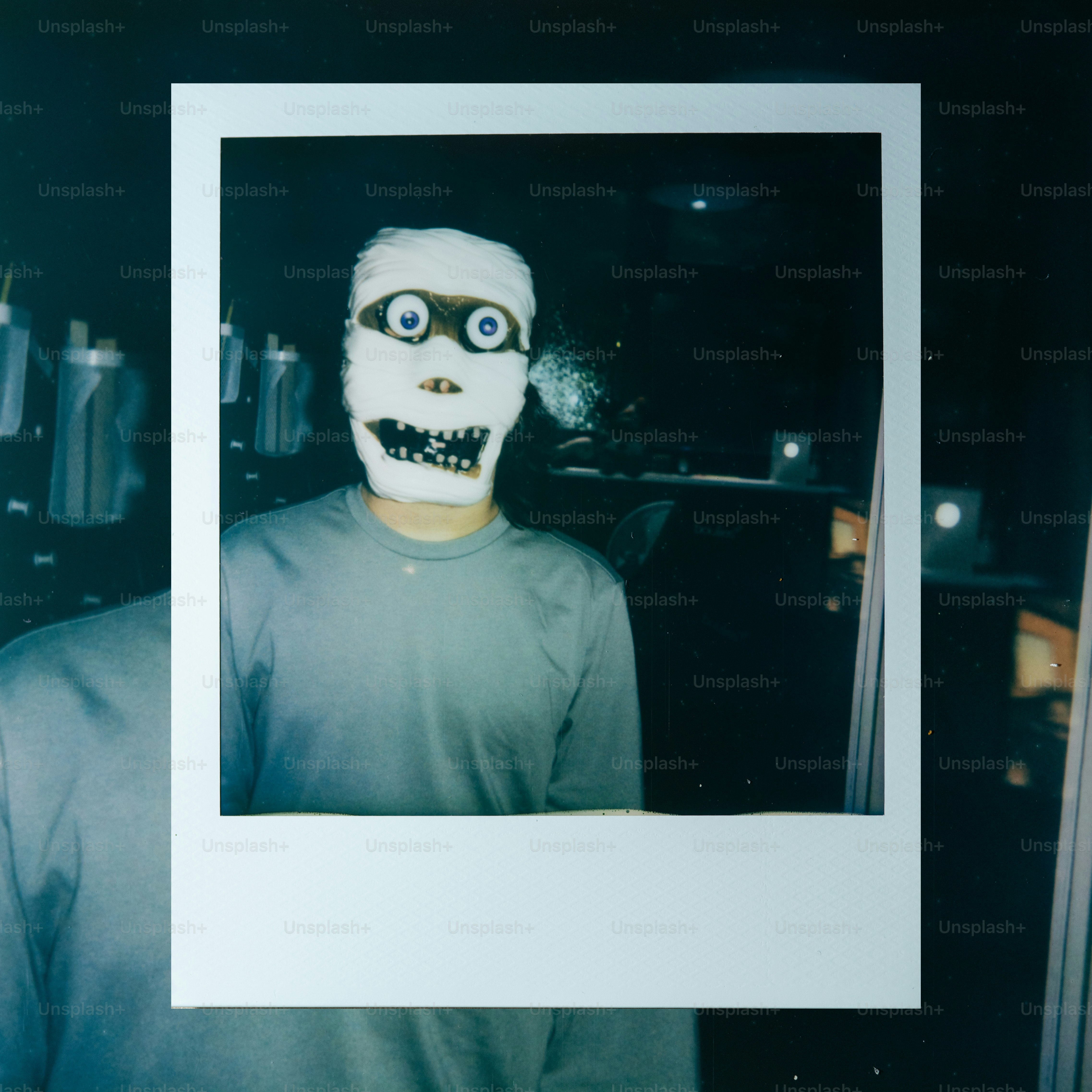 Person wearing a mummy mask with wide eyes
