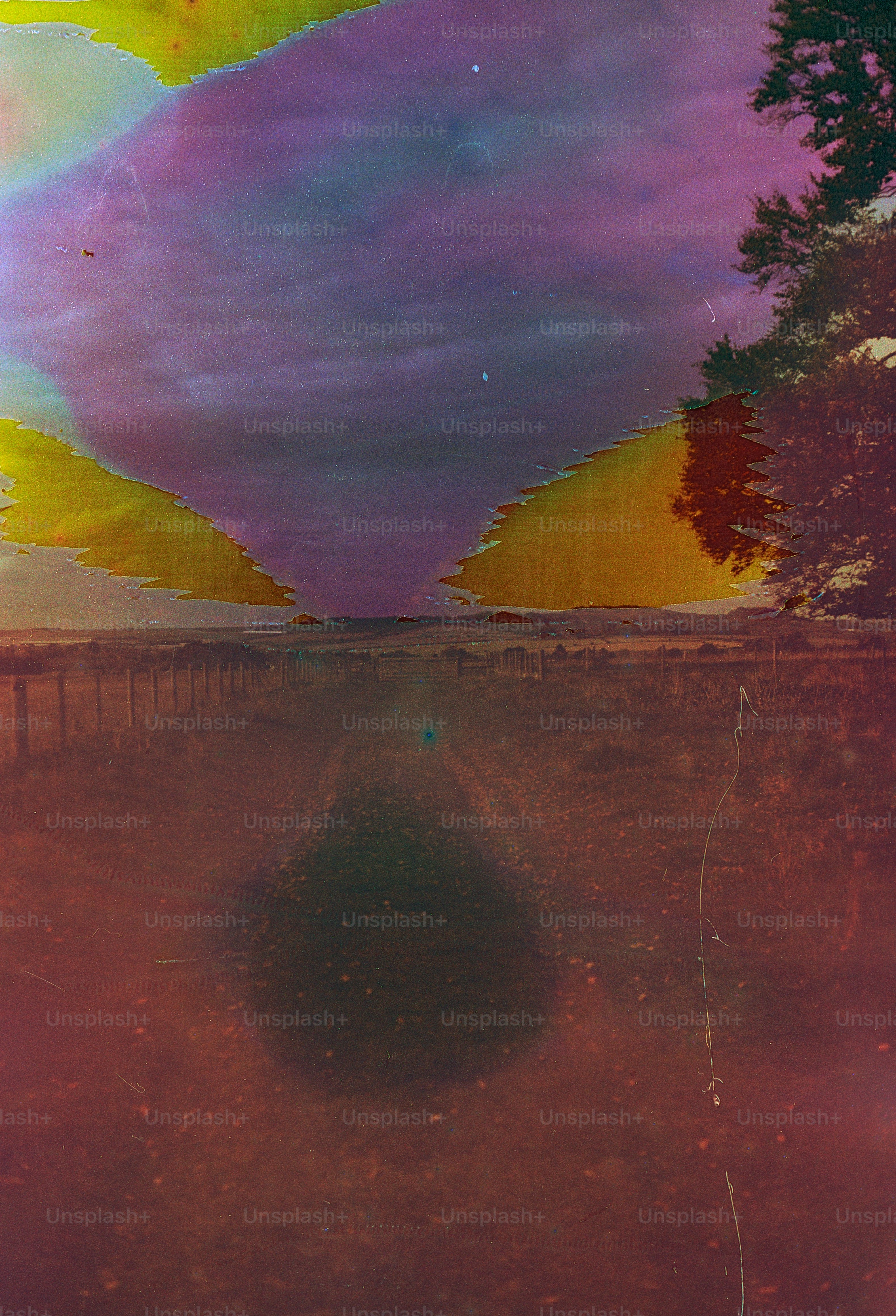 Abstract landscape with vibrant sky and field.