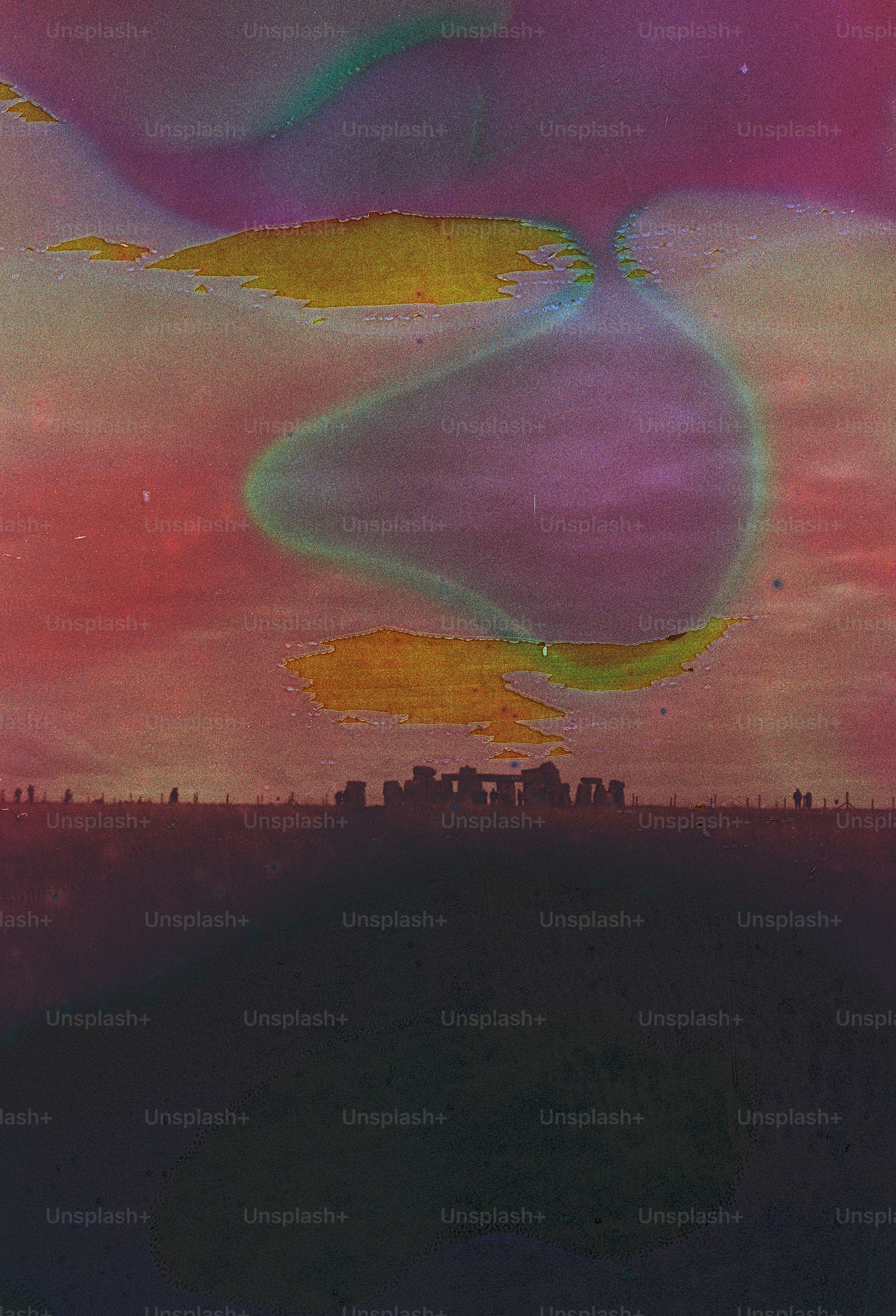 Stonehenge silhouetted against a colorful sunset sky