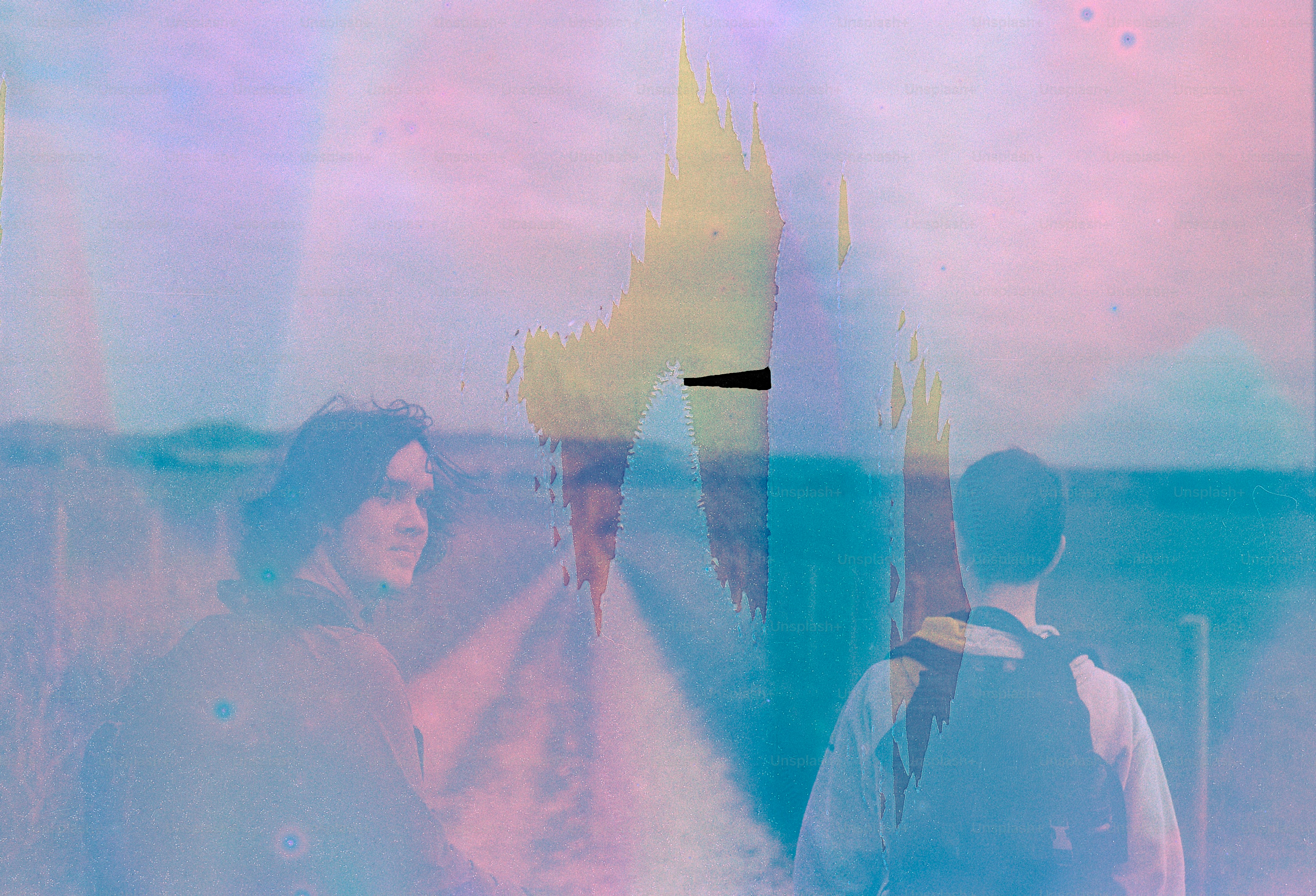 Two people looking out at a hazy landscape