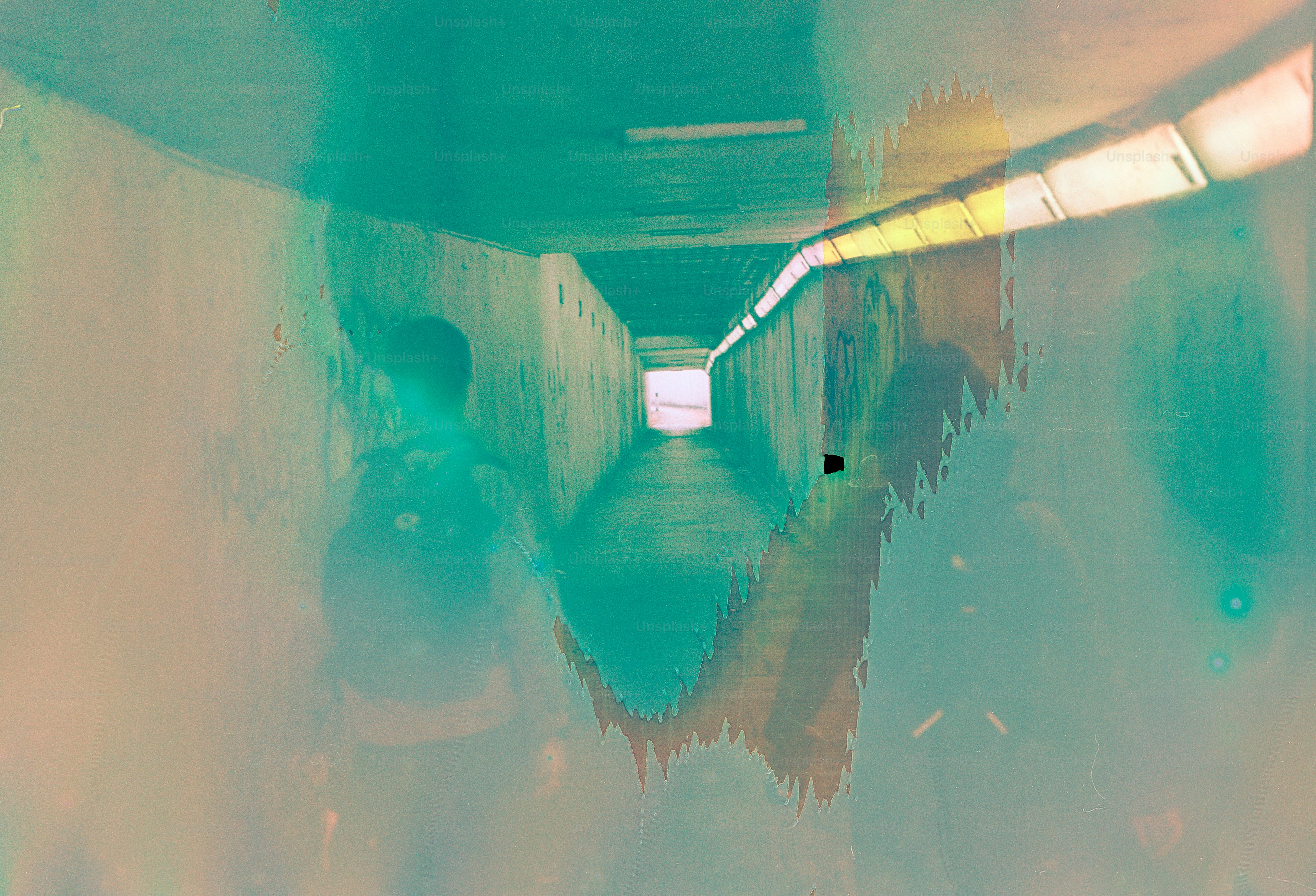 People walk through a brightly lit tunnel.