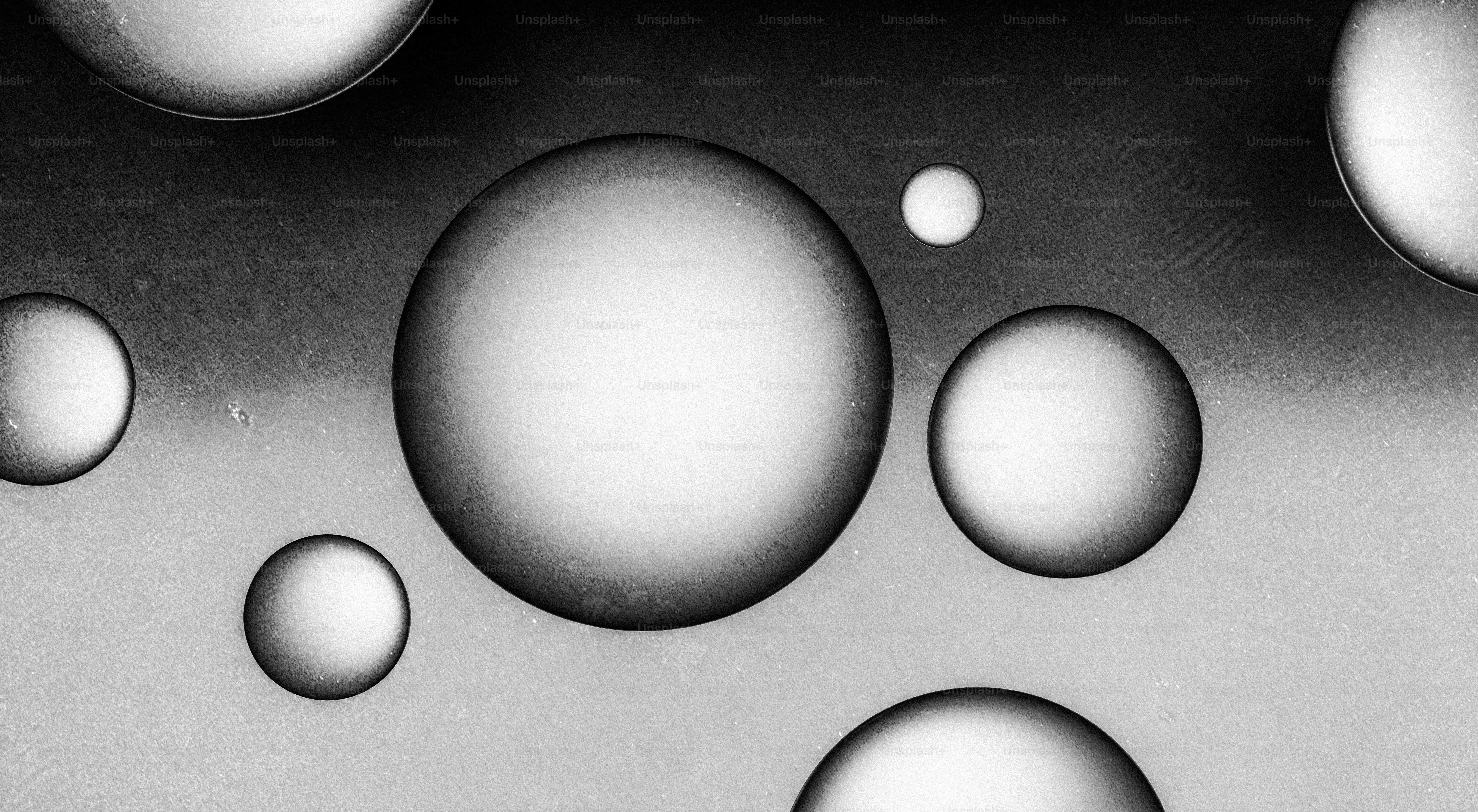 Several translucent spheres floating against a textured background ...