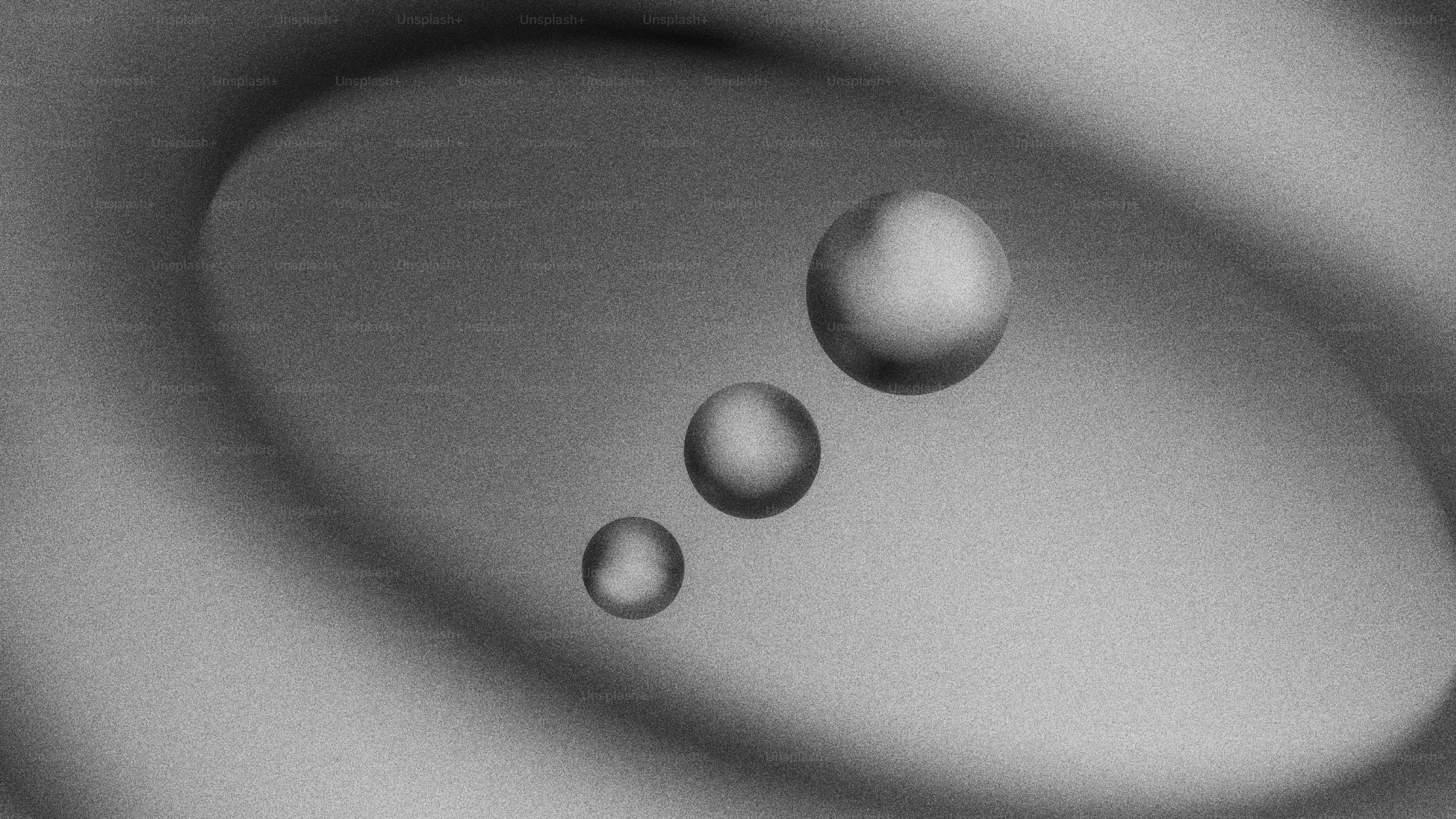 Three spheres floating in a textured oval