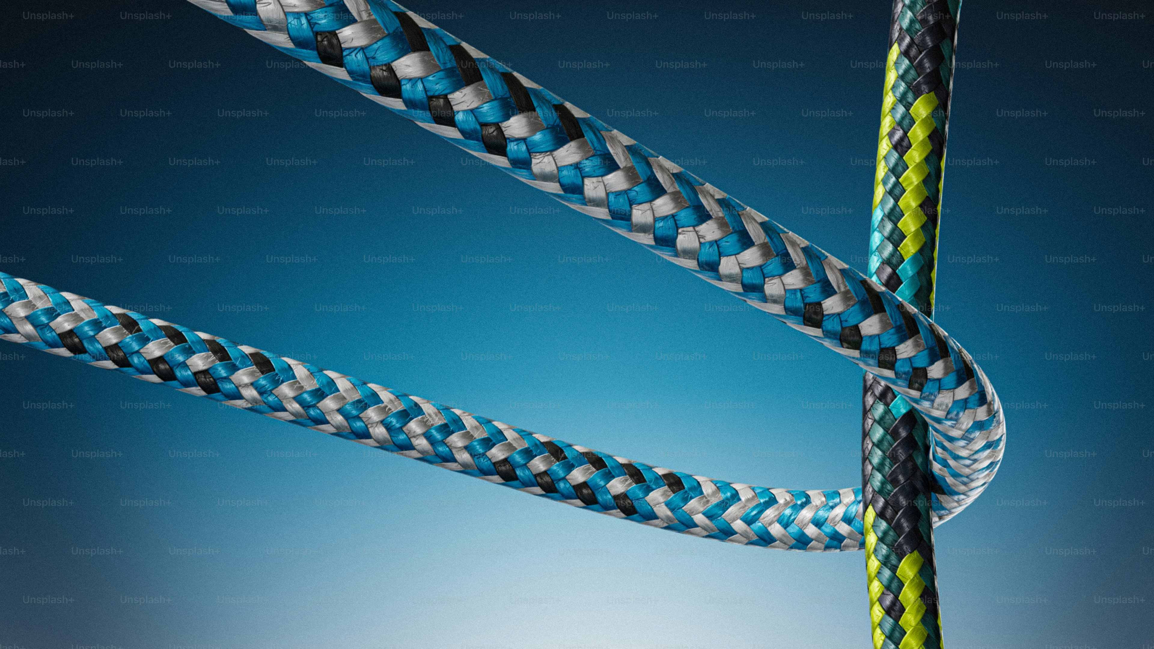 Close-up of braided rope against blue background