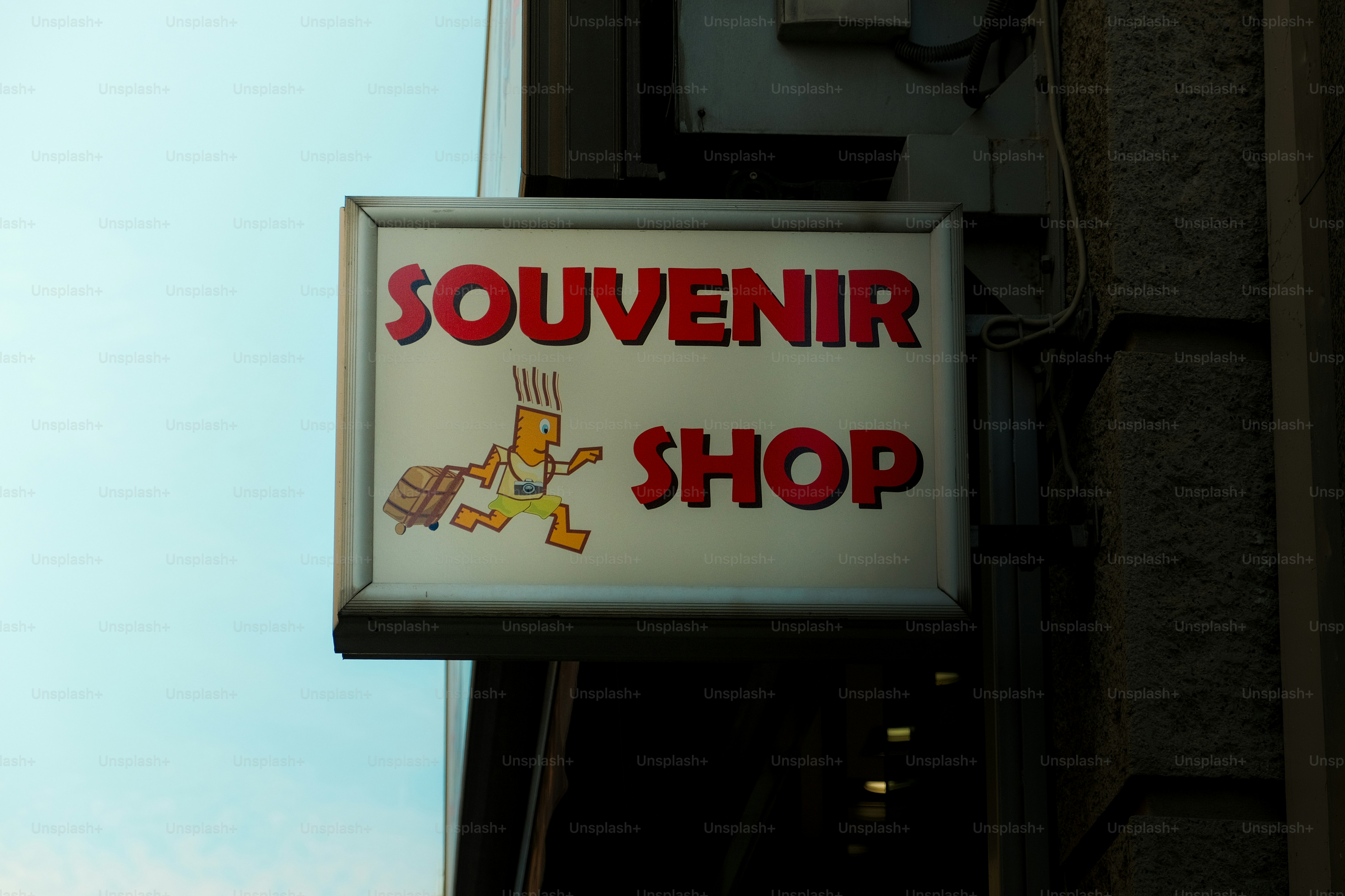 A lit sign for a souvenir shop