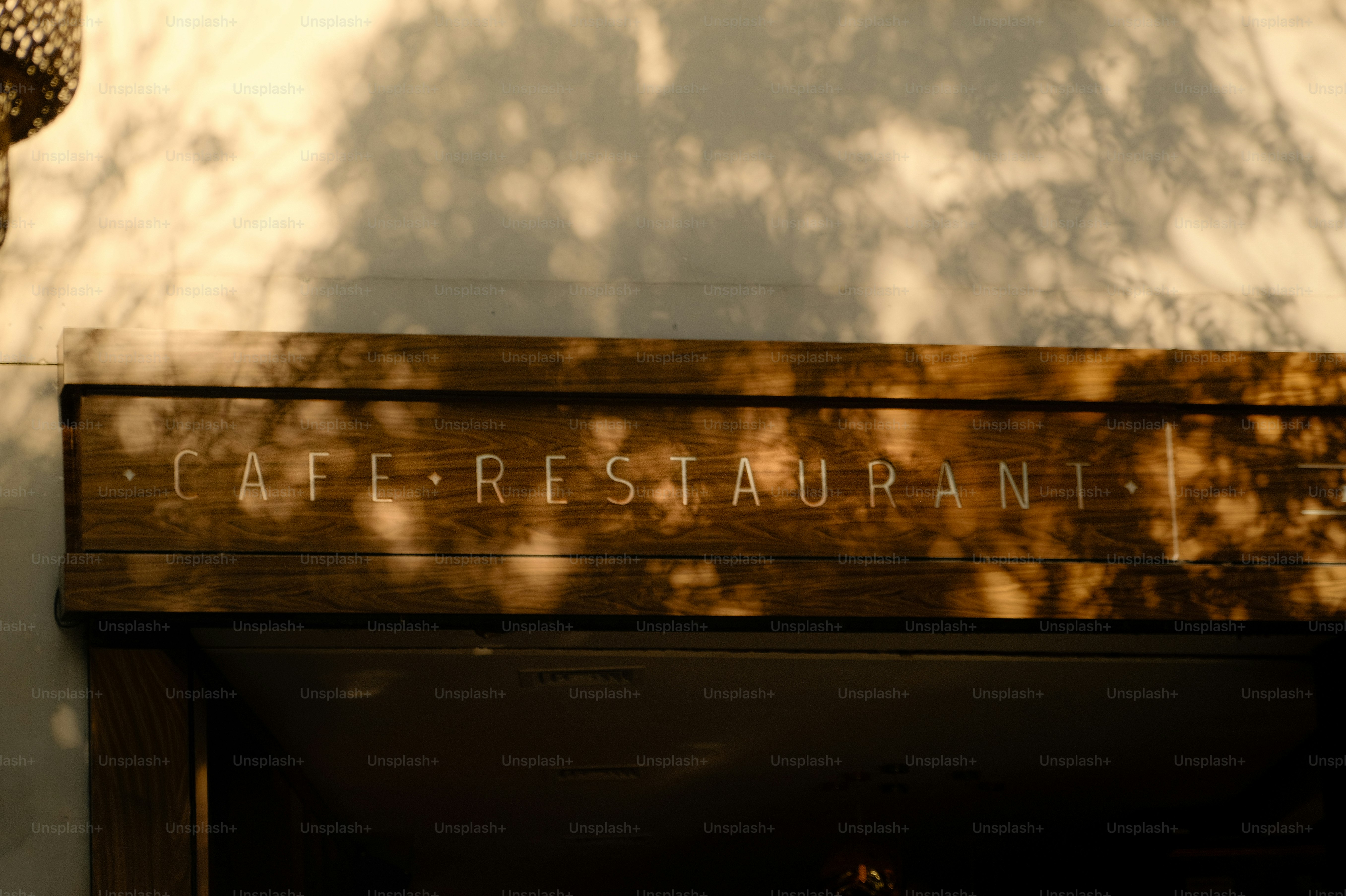 Cafe restaurant sign with dappled sunlight