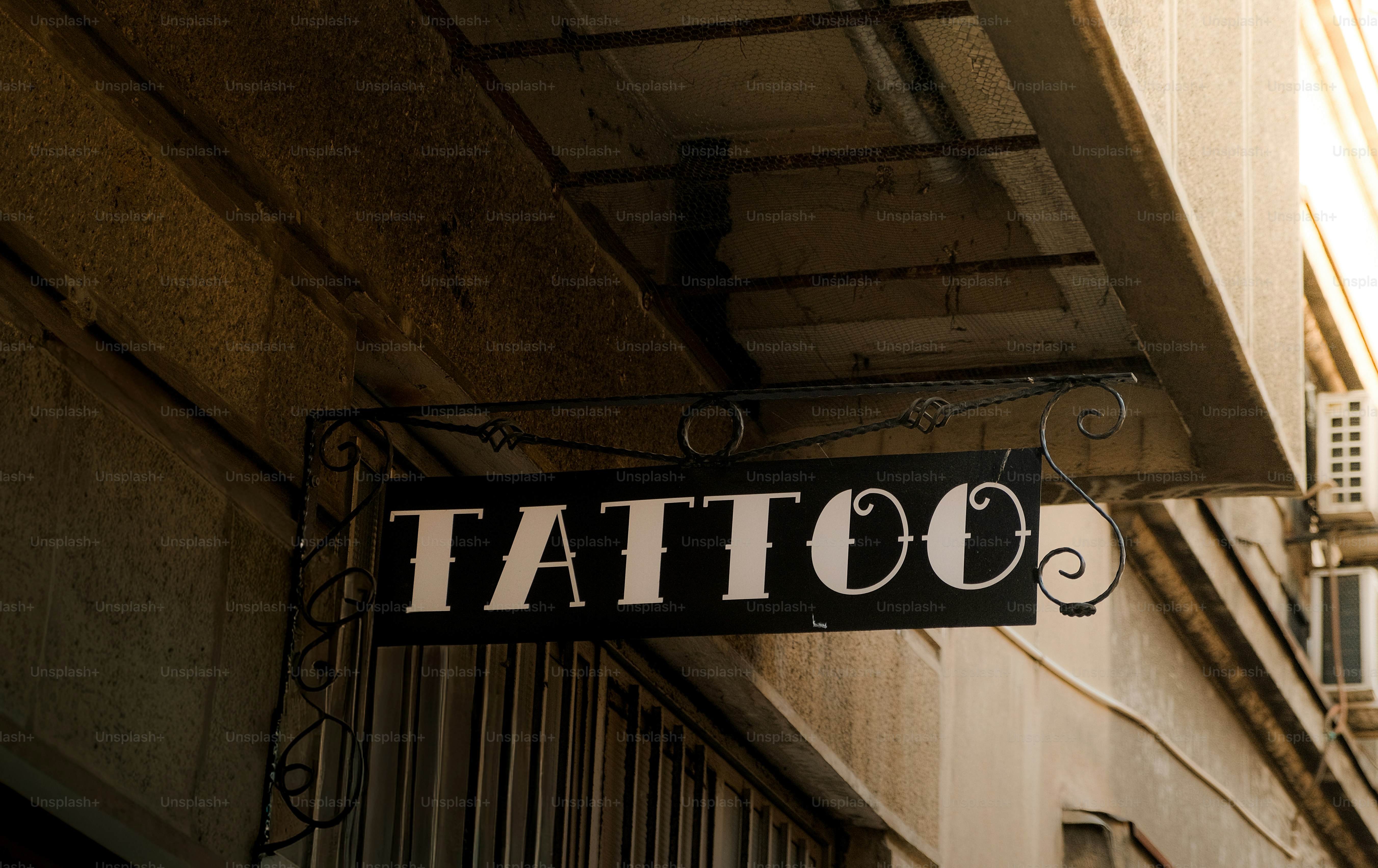 A black sign with the word tattoo