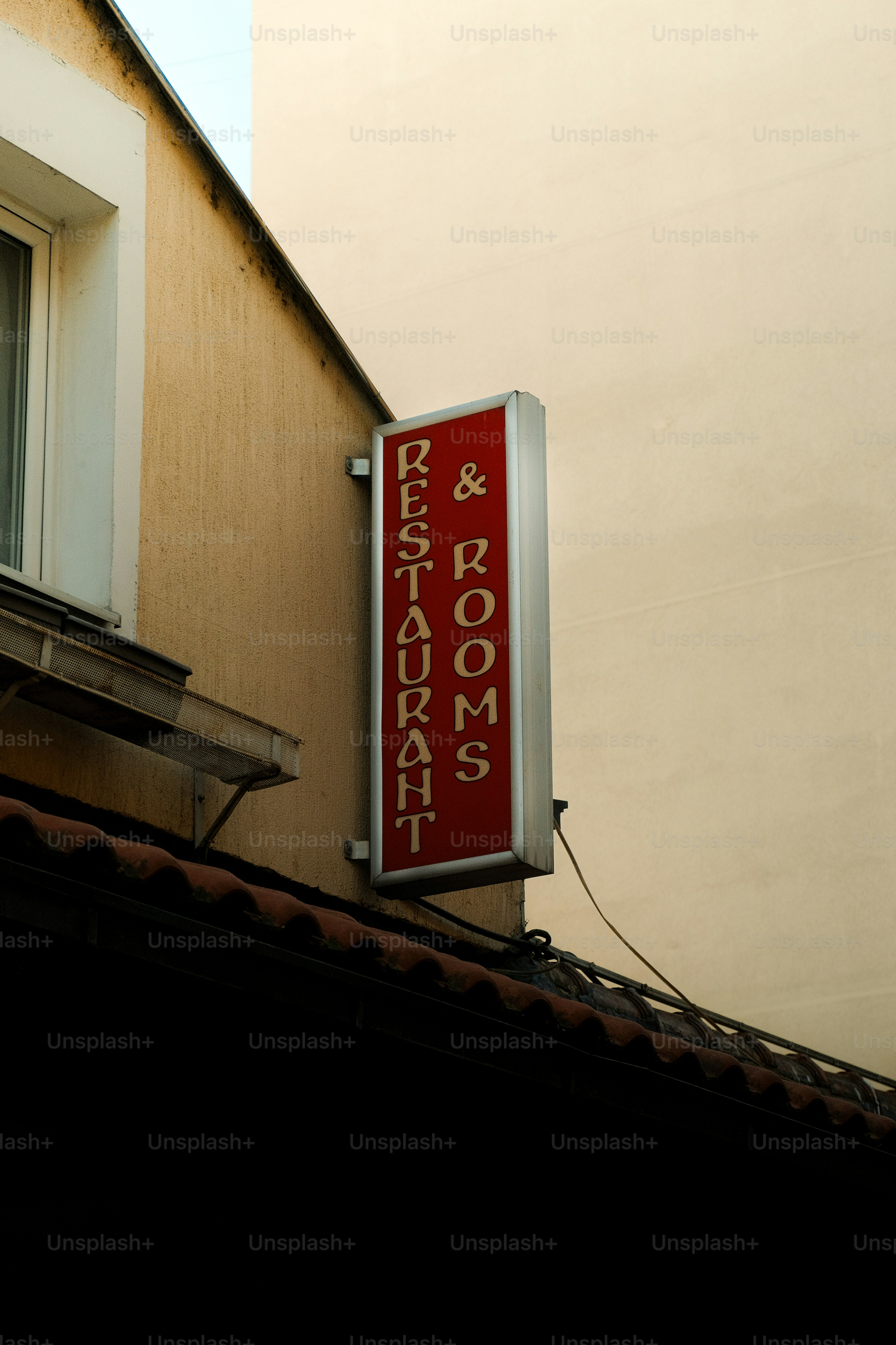 Red sign for restaurant and rooms
