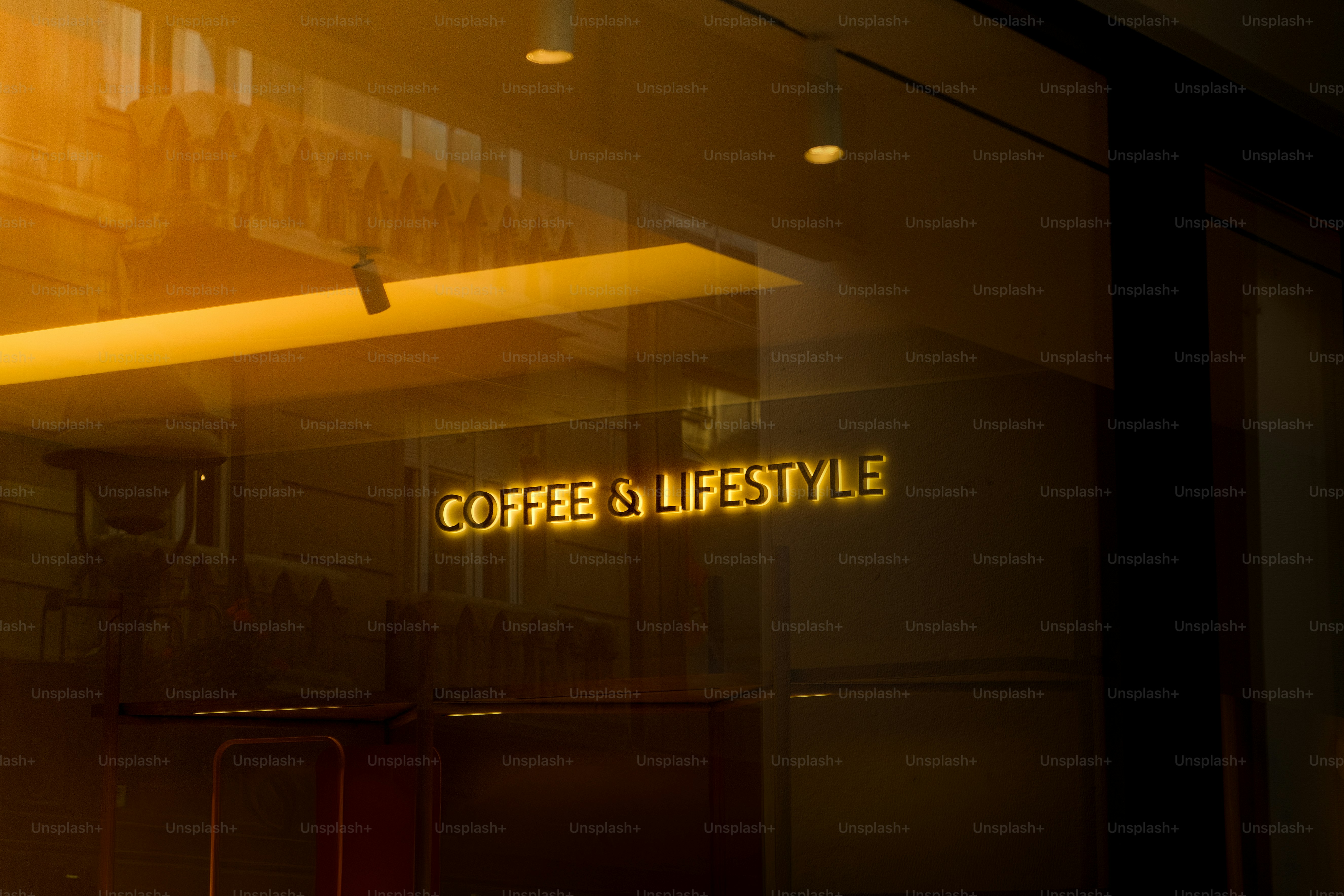 Golden text on glass reads coffee & lifestyle