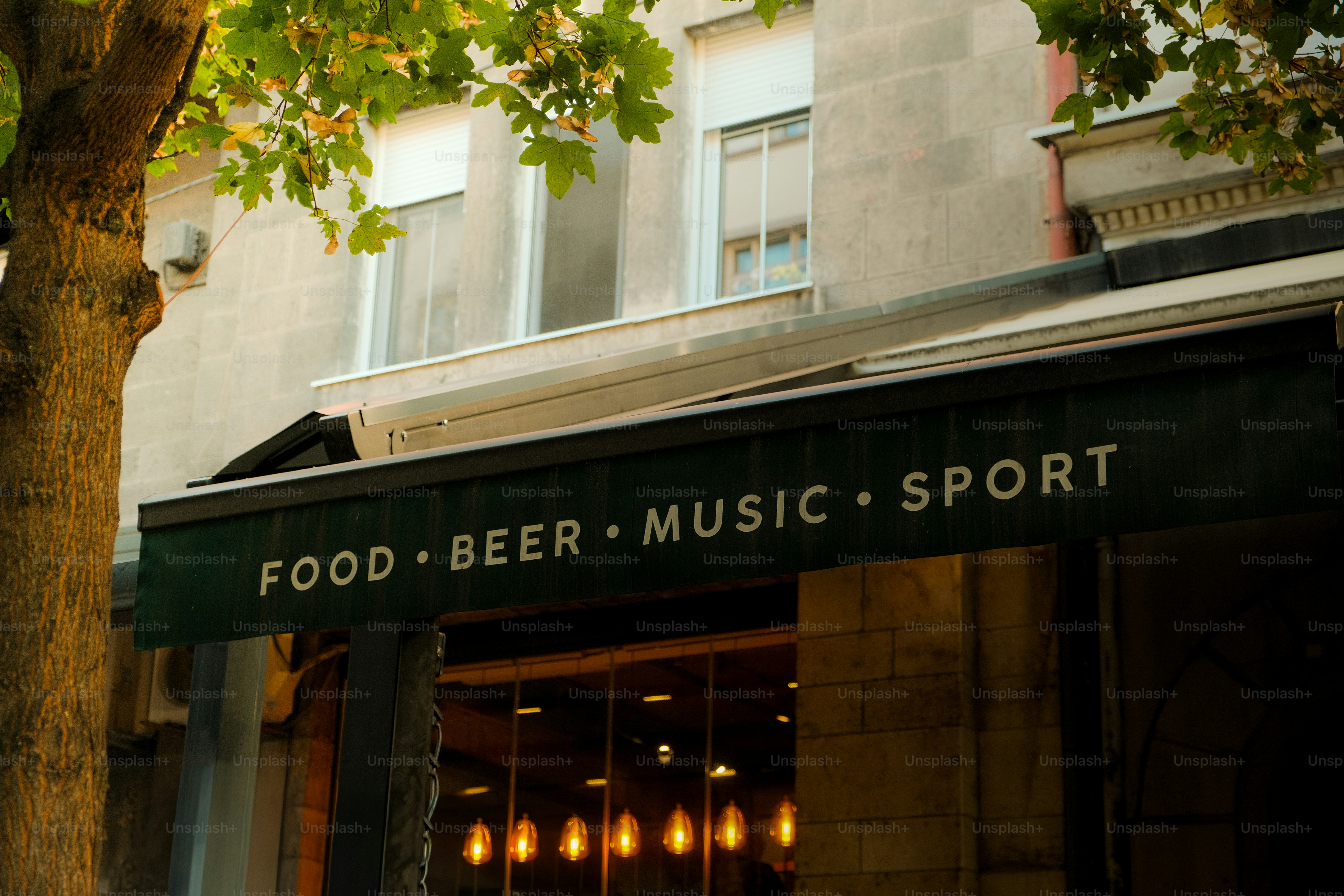 A building facade with "food beer music sport" sign.
