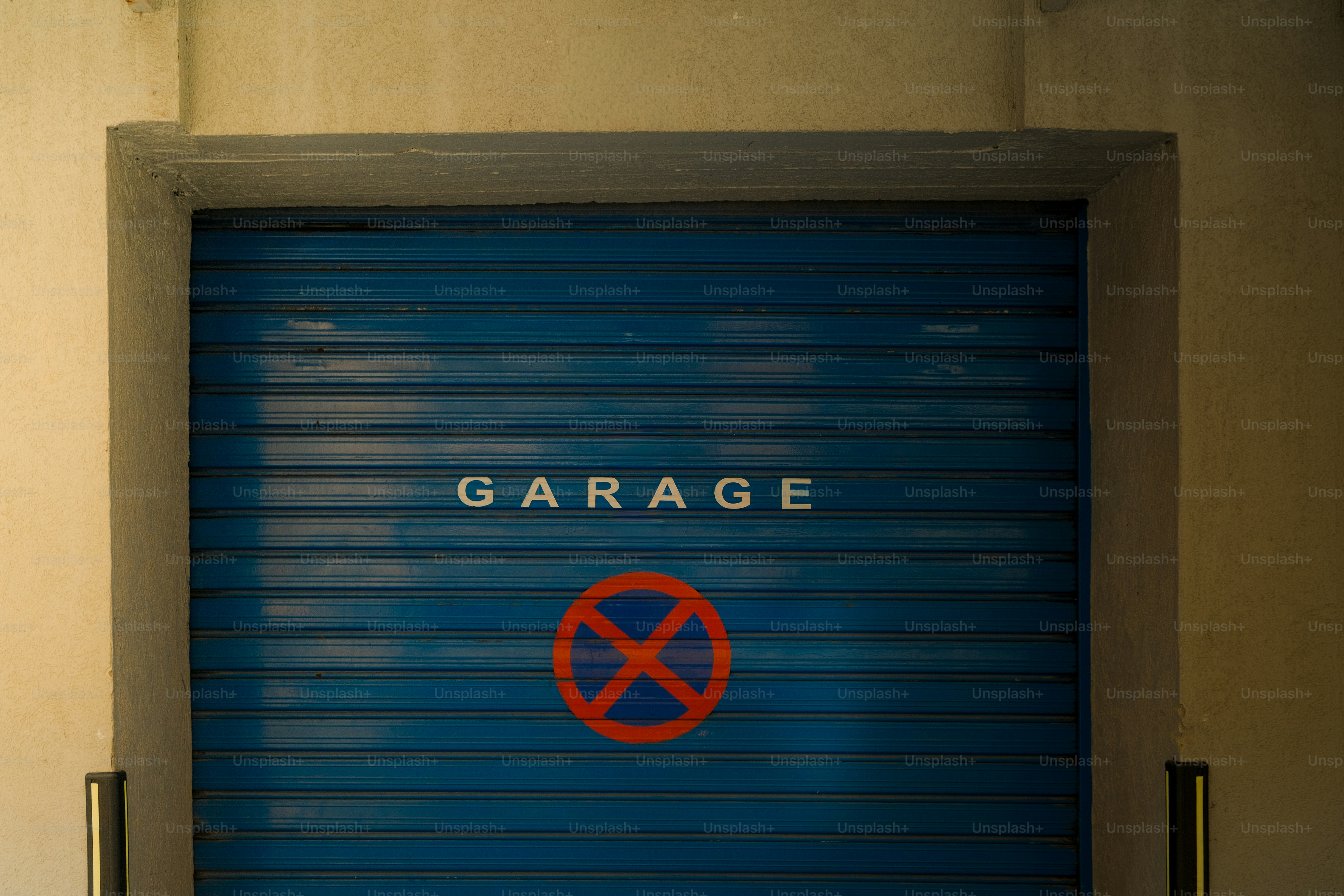 Blue garage door with a red no parking sign.