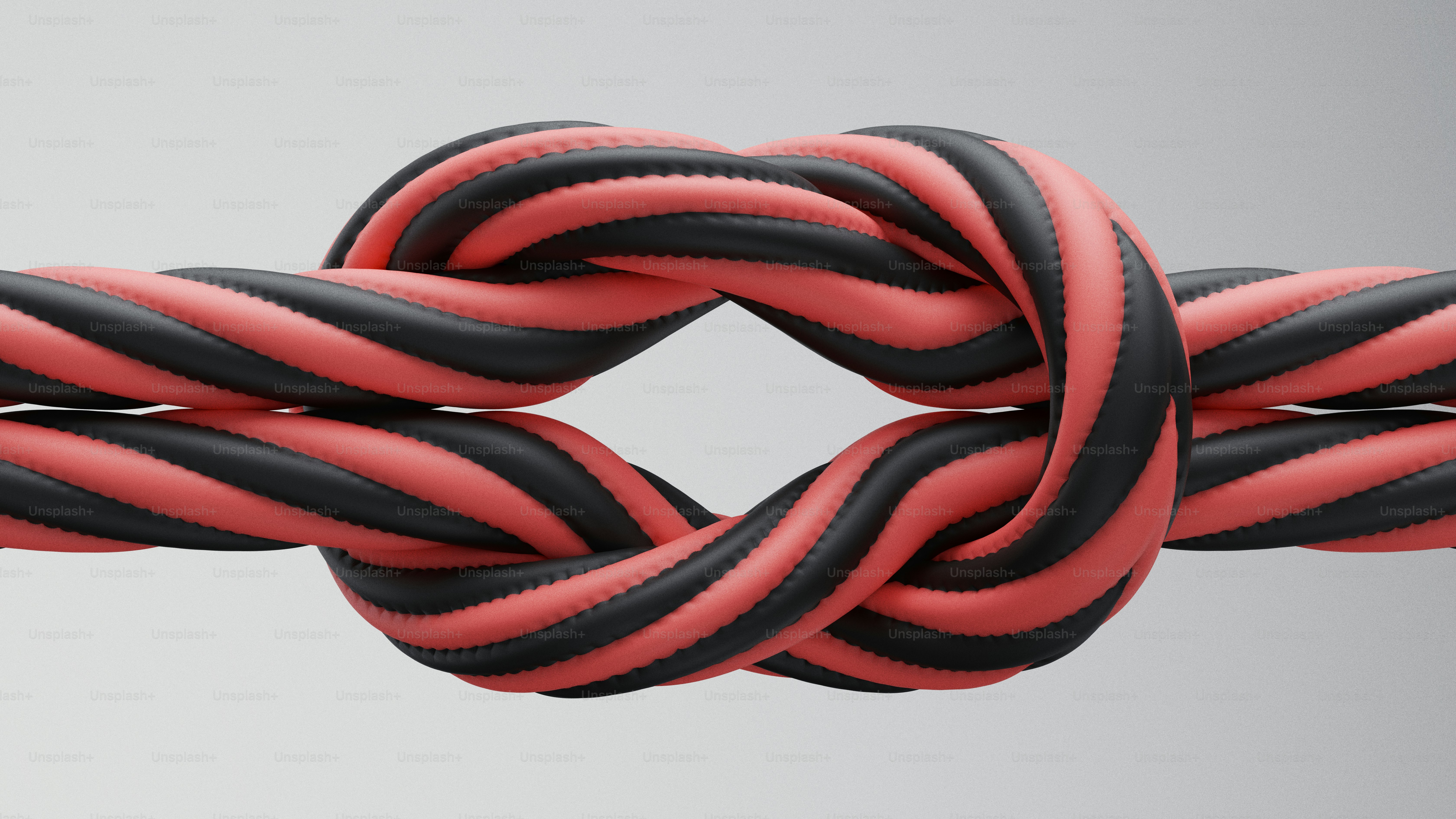 Zwei geflochtene Kordeln, die zu einem Knoten gebunden sind