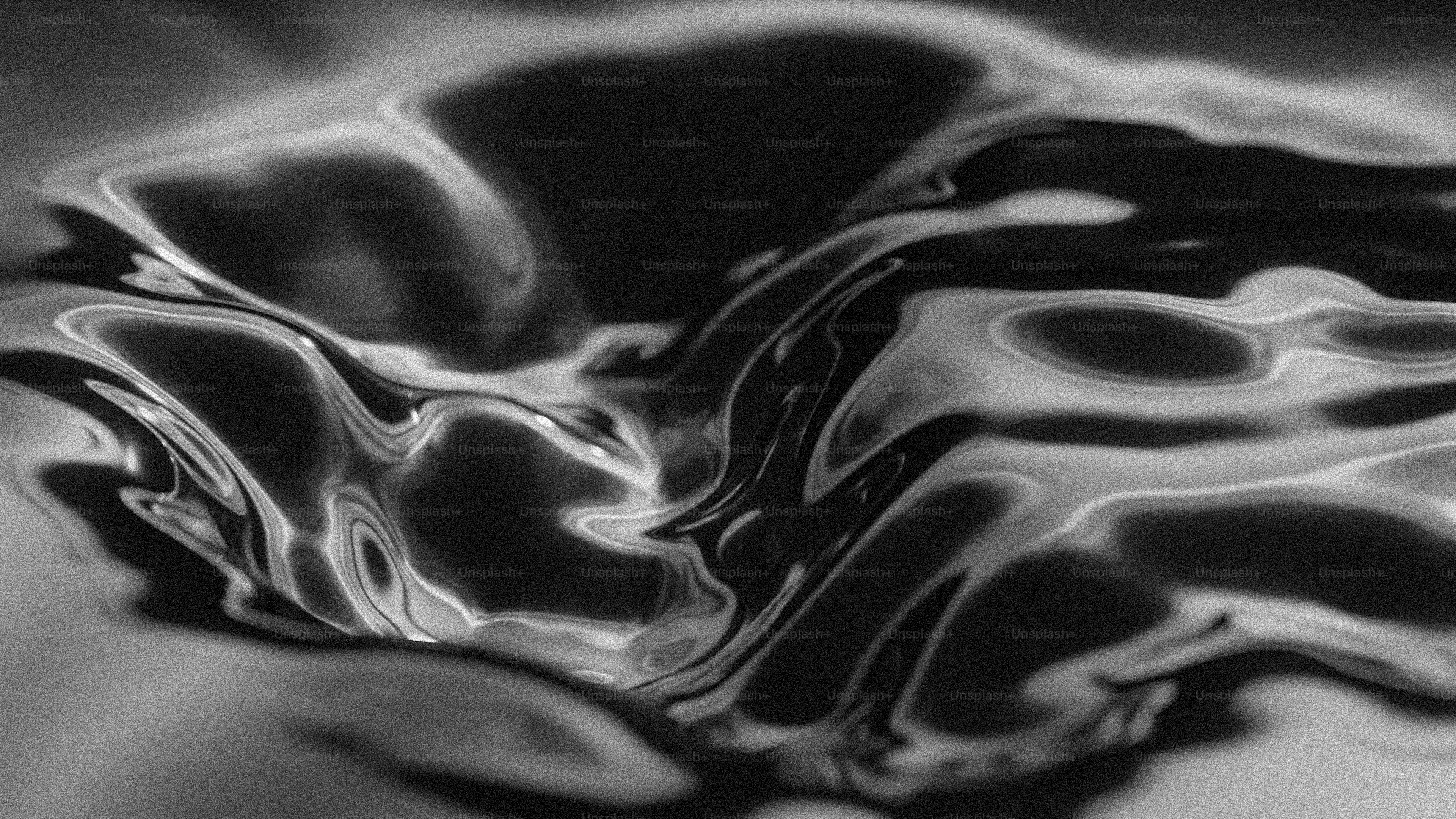 Abstract dark liquid surface with bright highlights