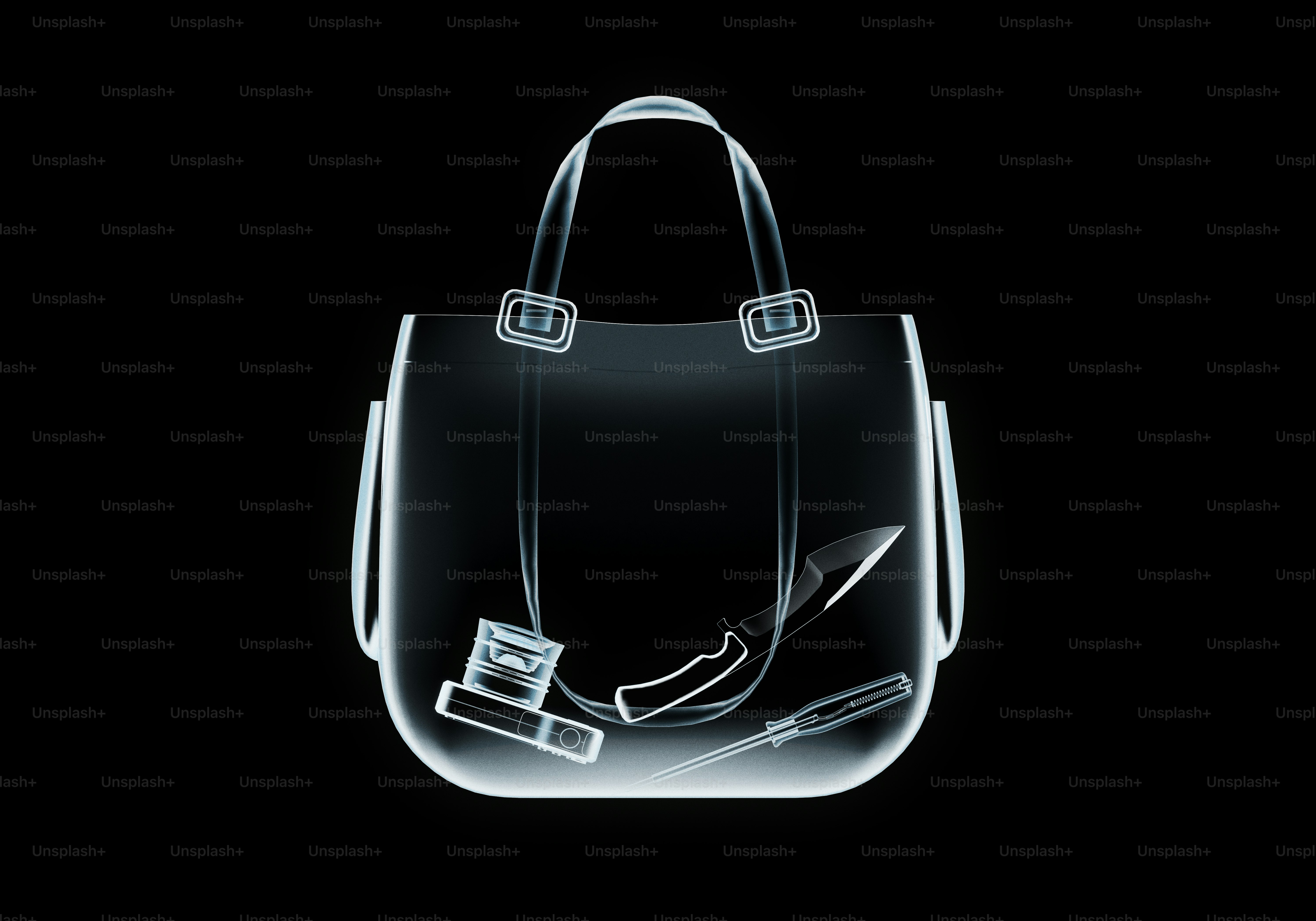 X-ray of a handbag with knife and screwdriver.