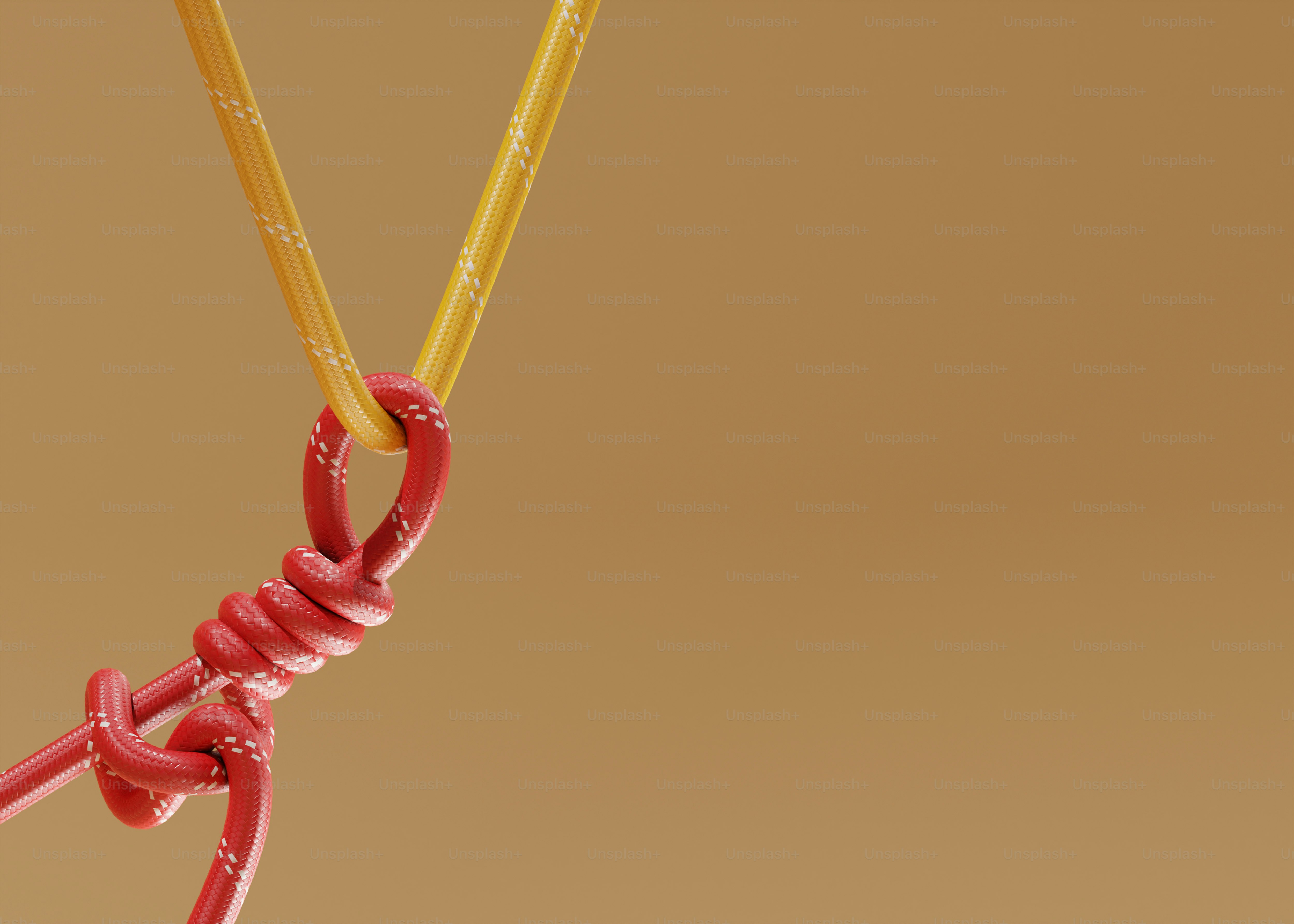 Red and yellow ropes tied together with a knot photo – Abstract Image ...