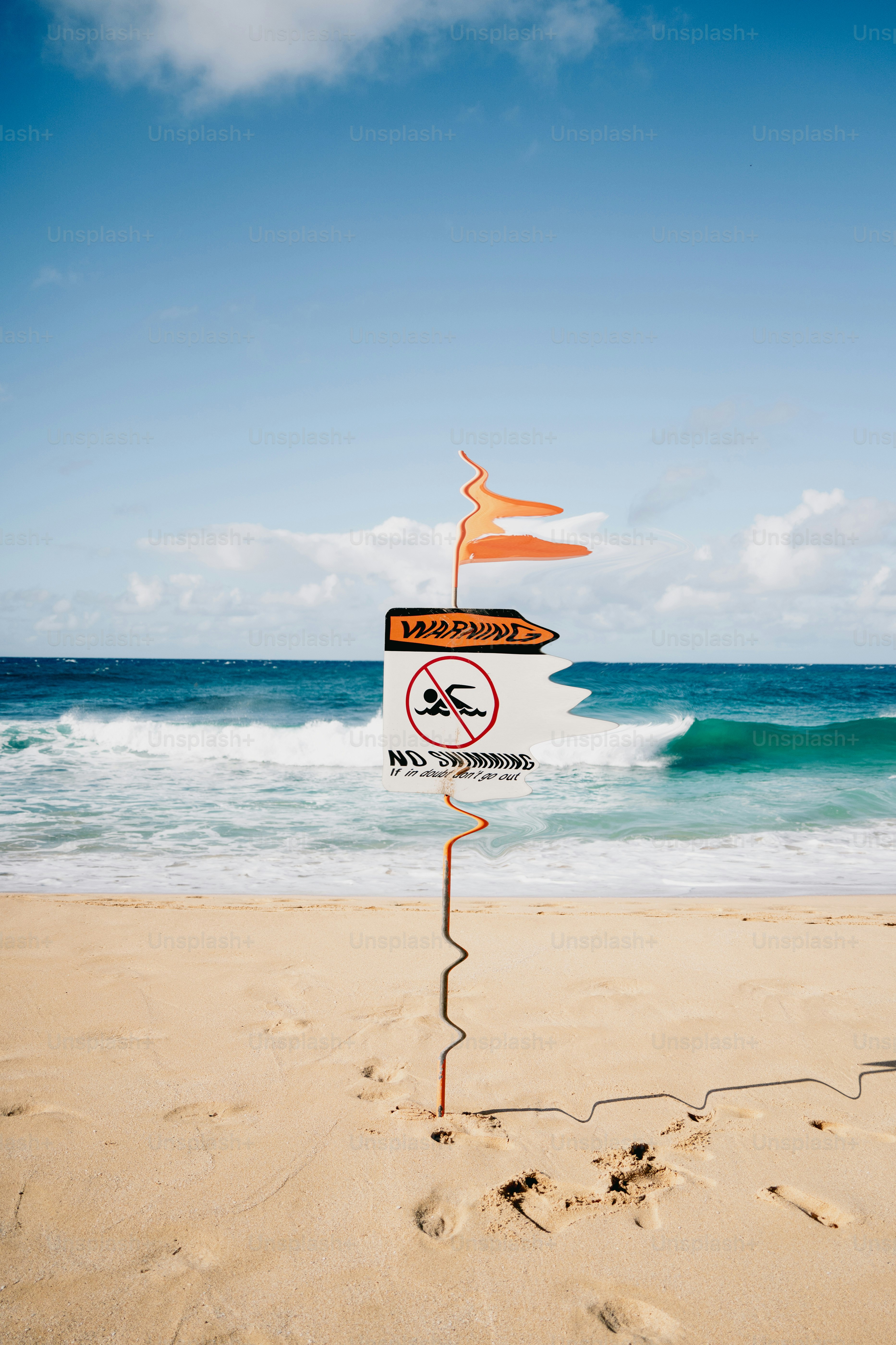 Warning sign on beach with no swimming symbol.