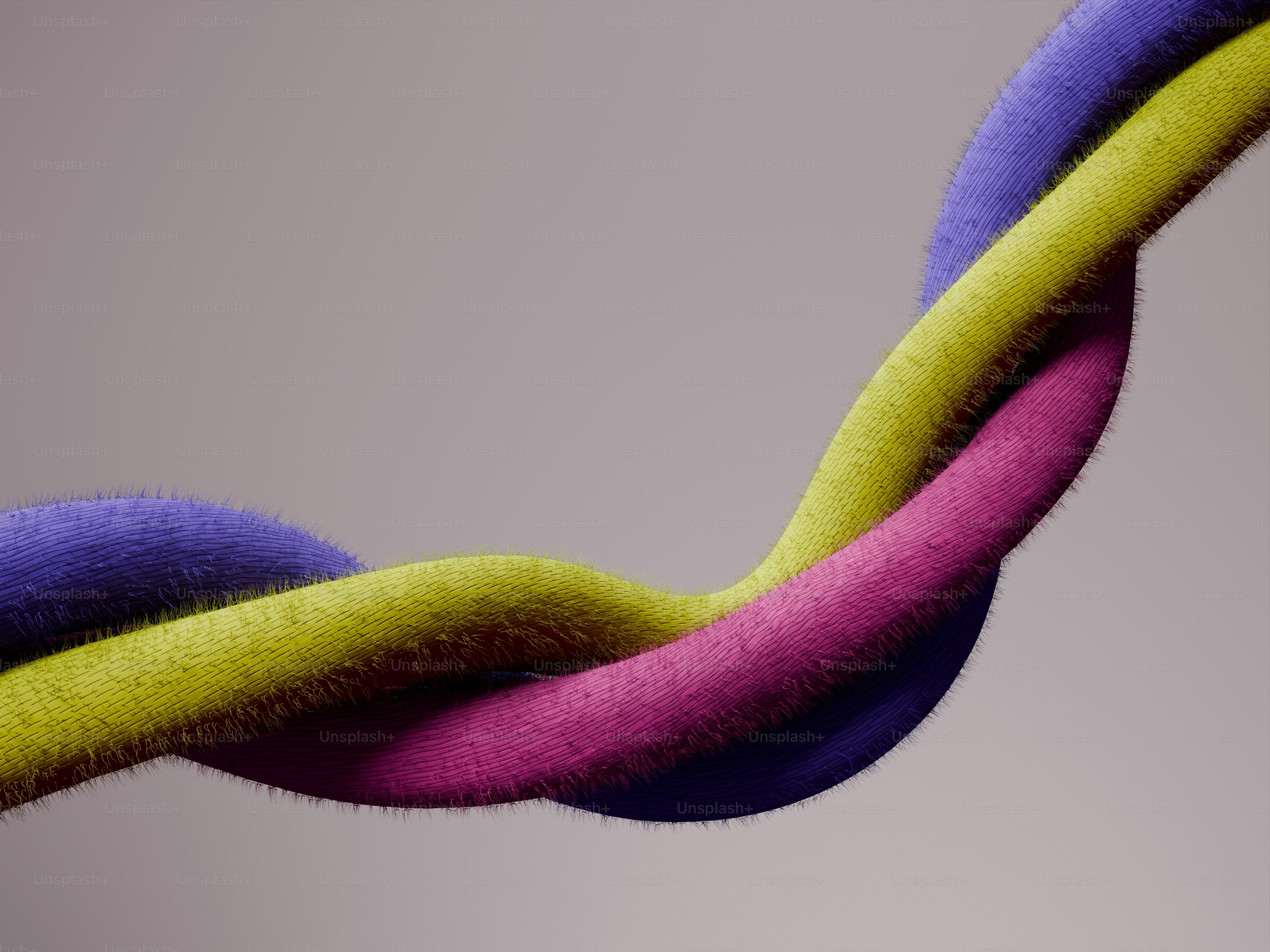 Tre corde sfocate colorate intrecciate insieme.