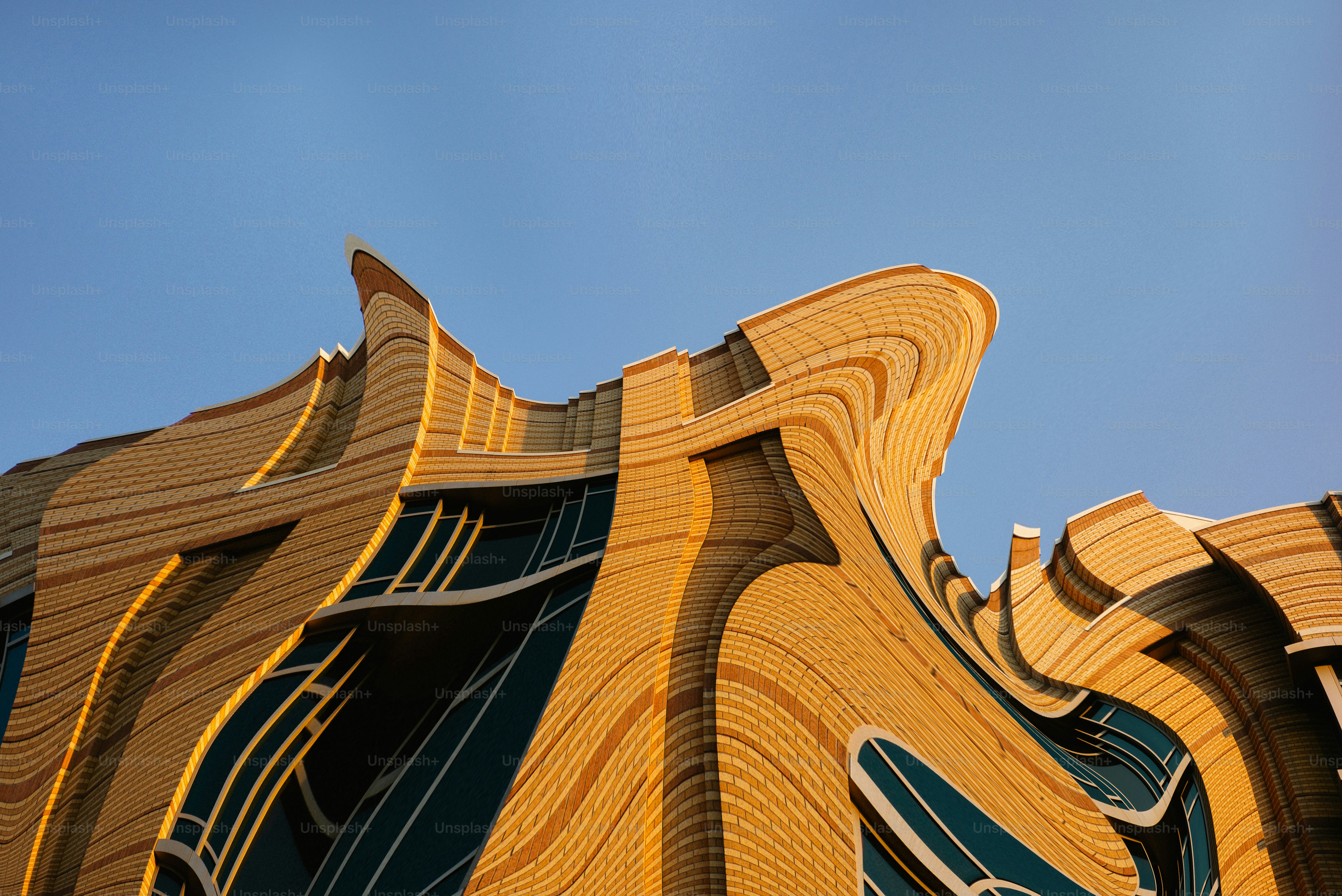 Distorted building facade against a clear blue sky