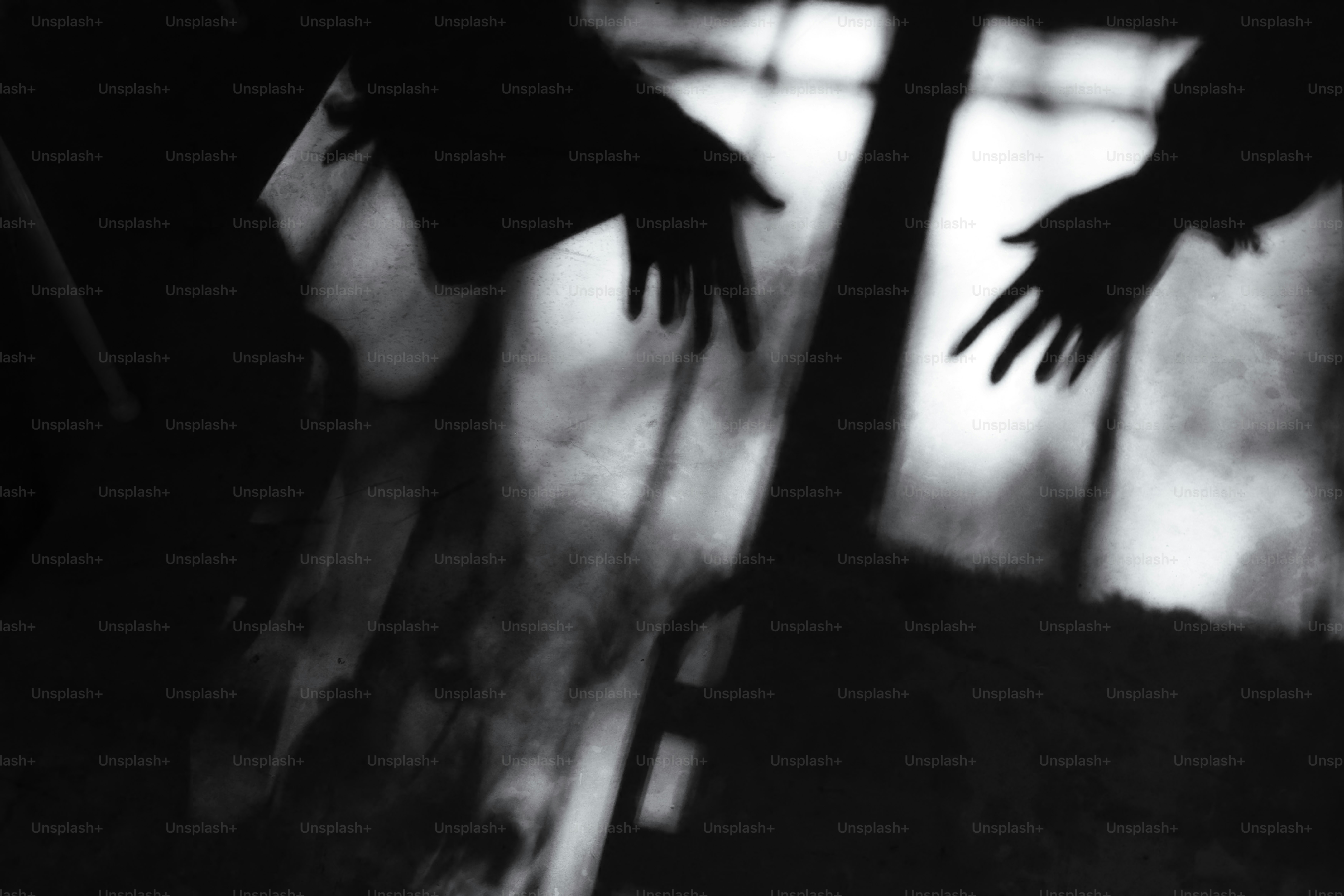 Silhouettes of two hands reaching towards each other.