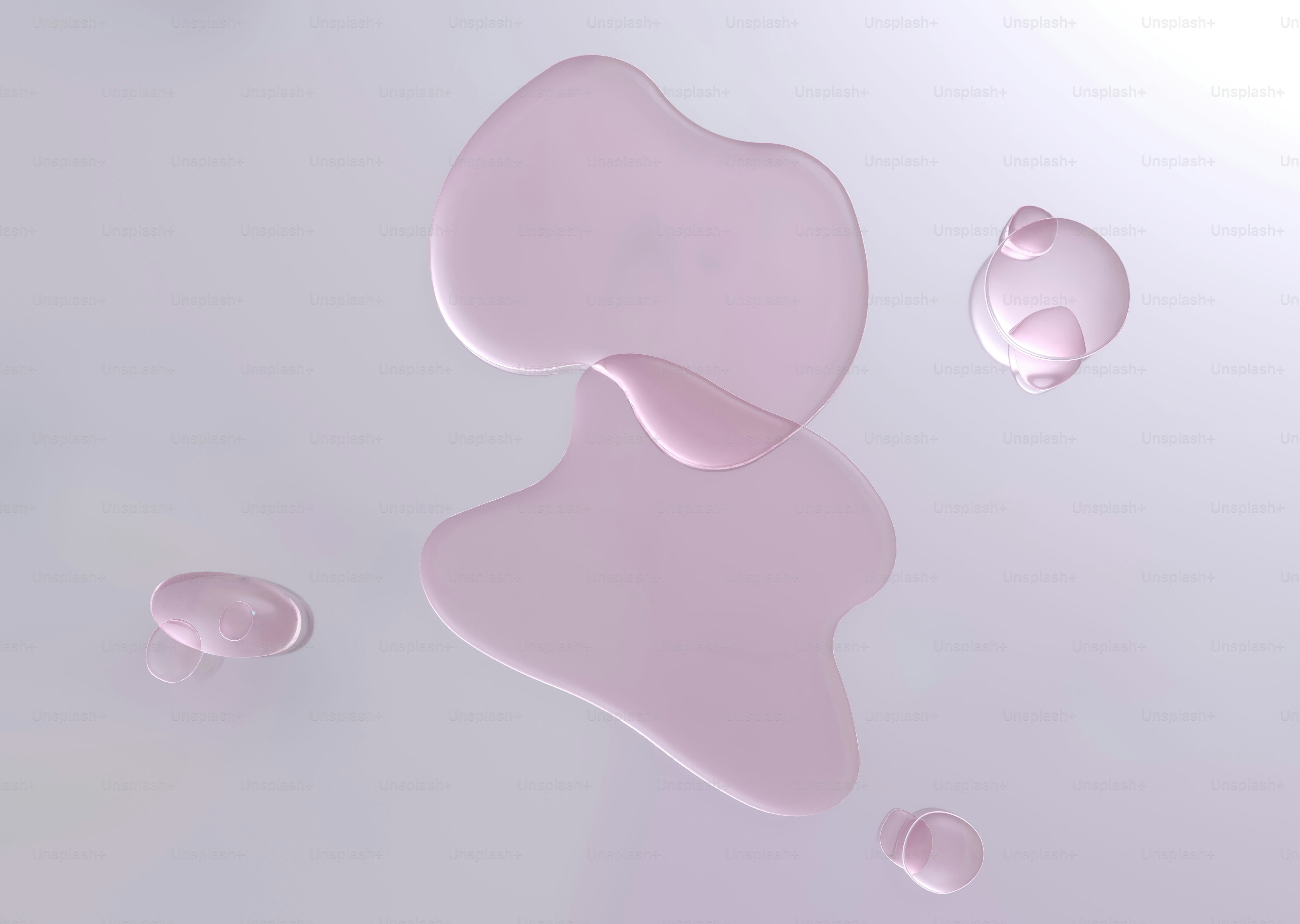 Pink liquid blobs on a light gray surface