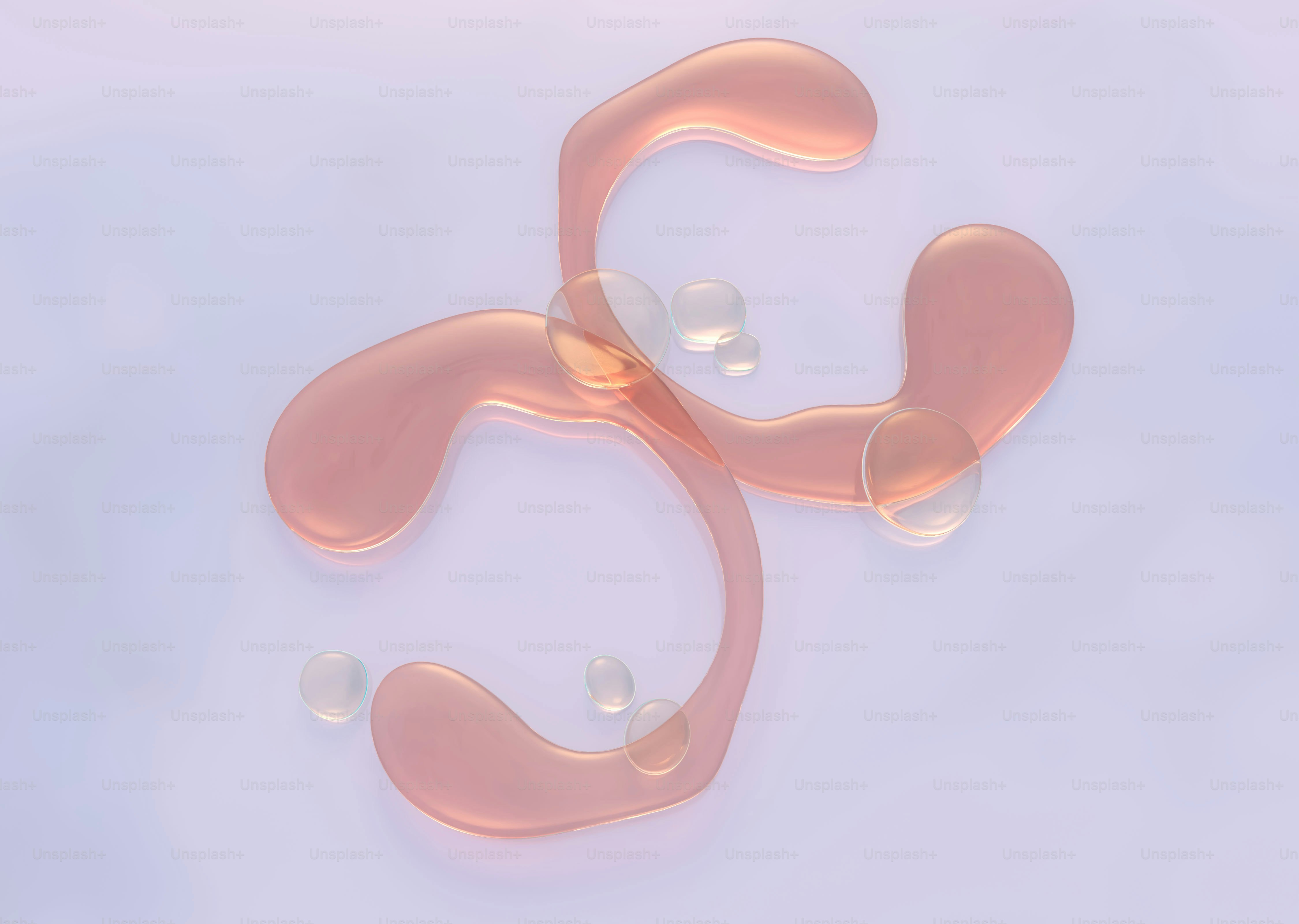 Pink liquid forming abstract shapes on white surface
