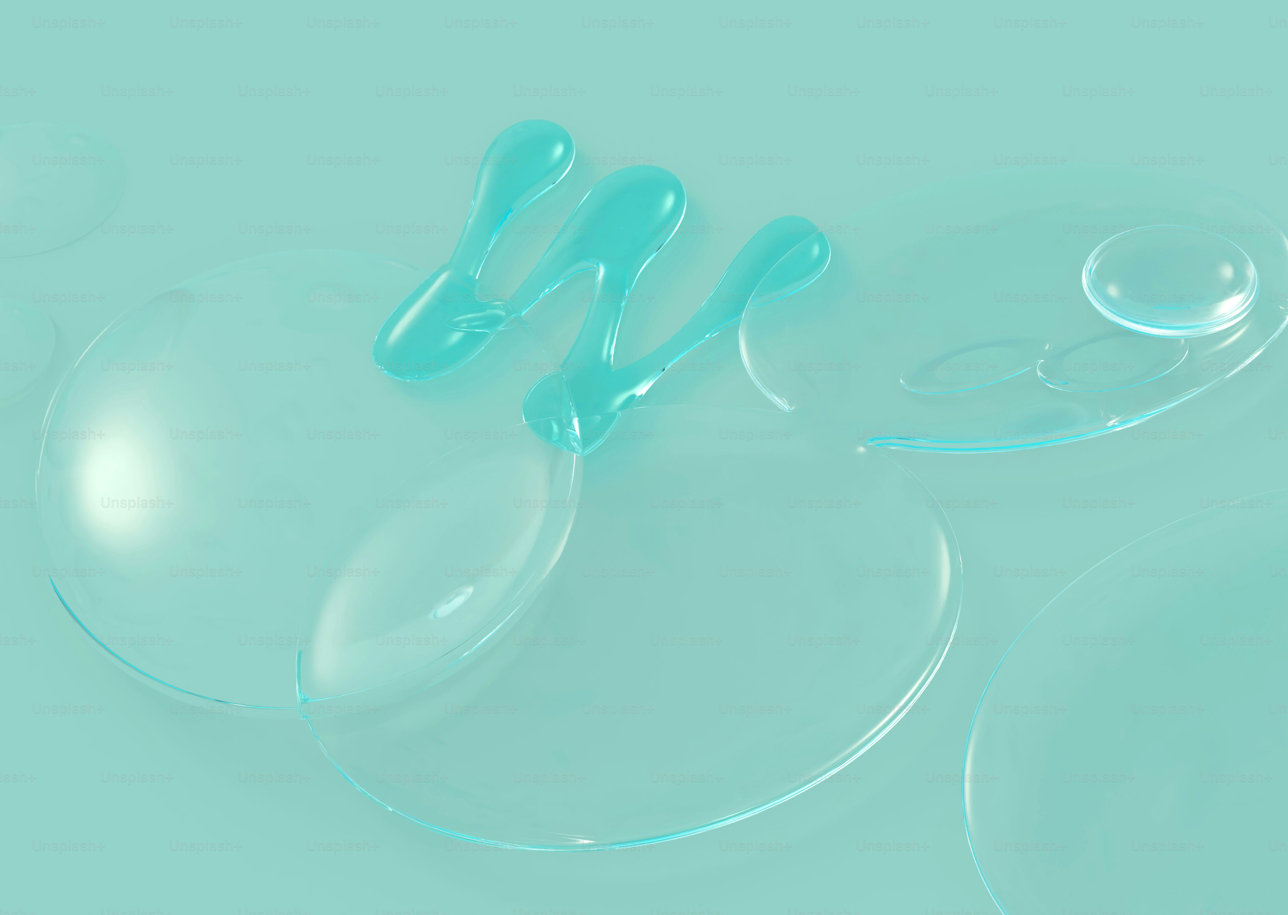 Turquoise liquid drops on a clear surface.