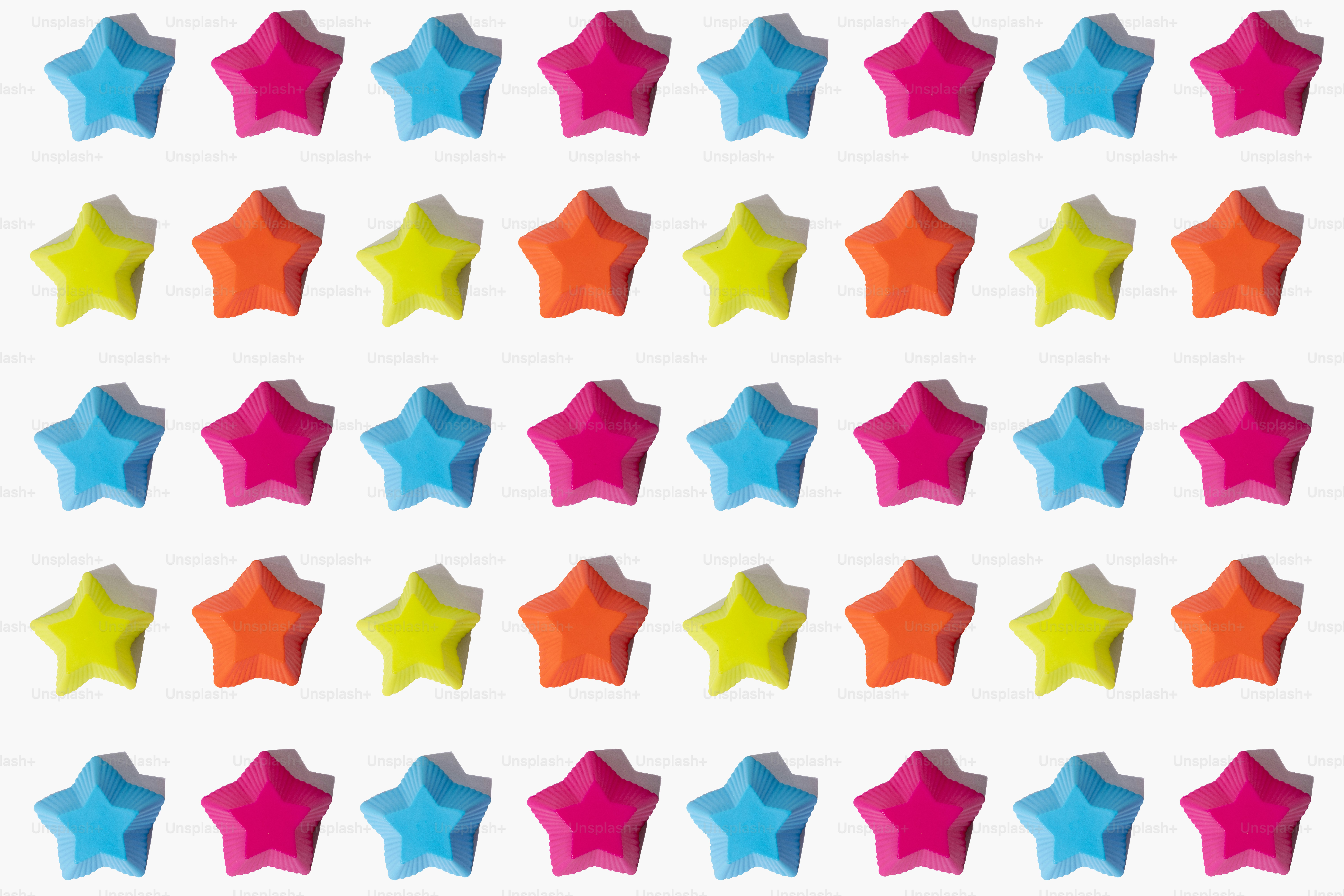 A pattern of colorful star shapes on a white background
