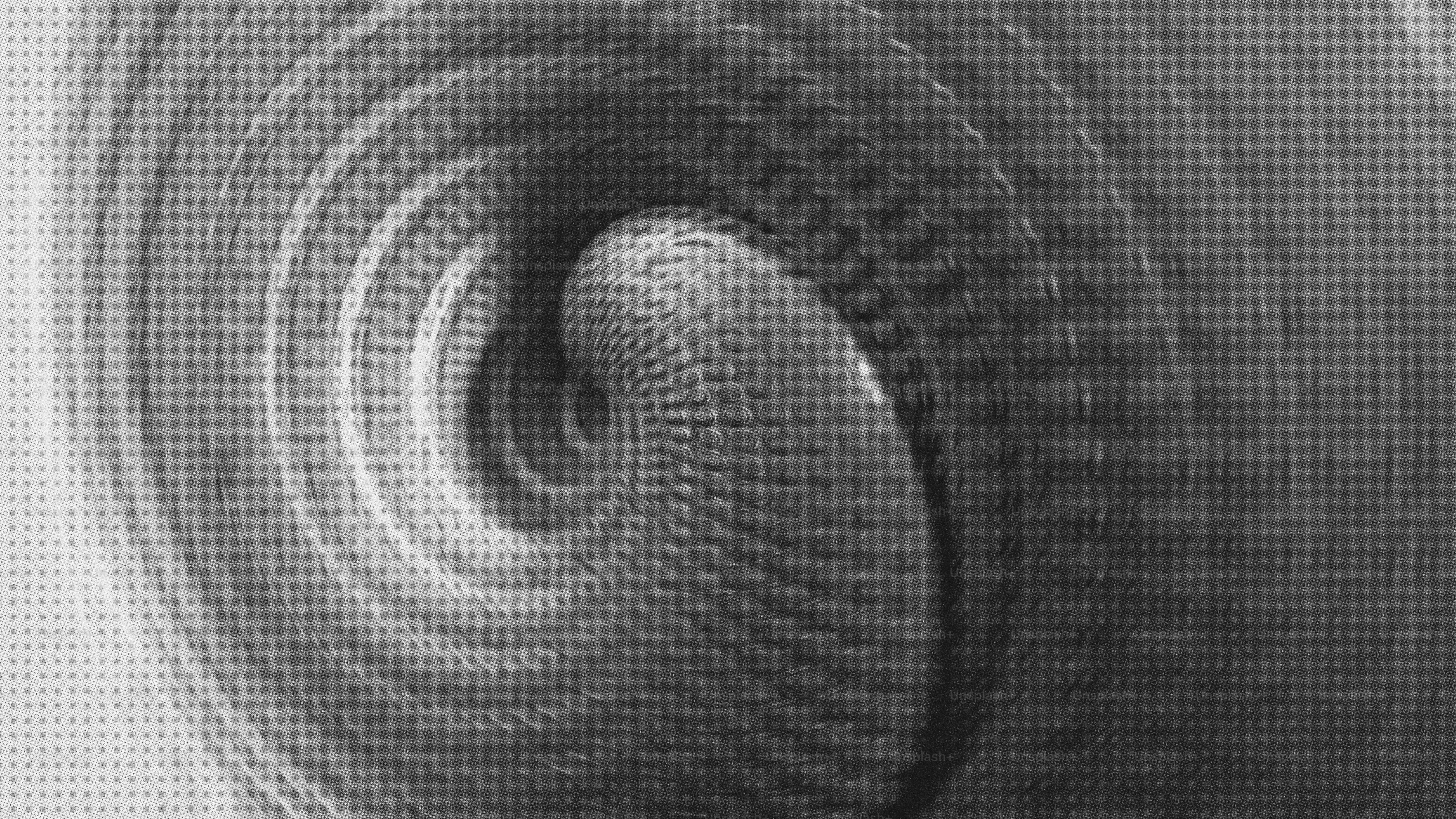 Abstract grayscale spiral pattern with textured detail