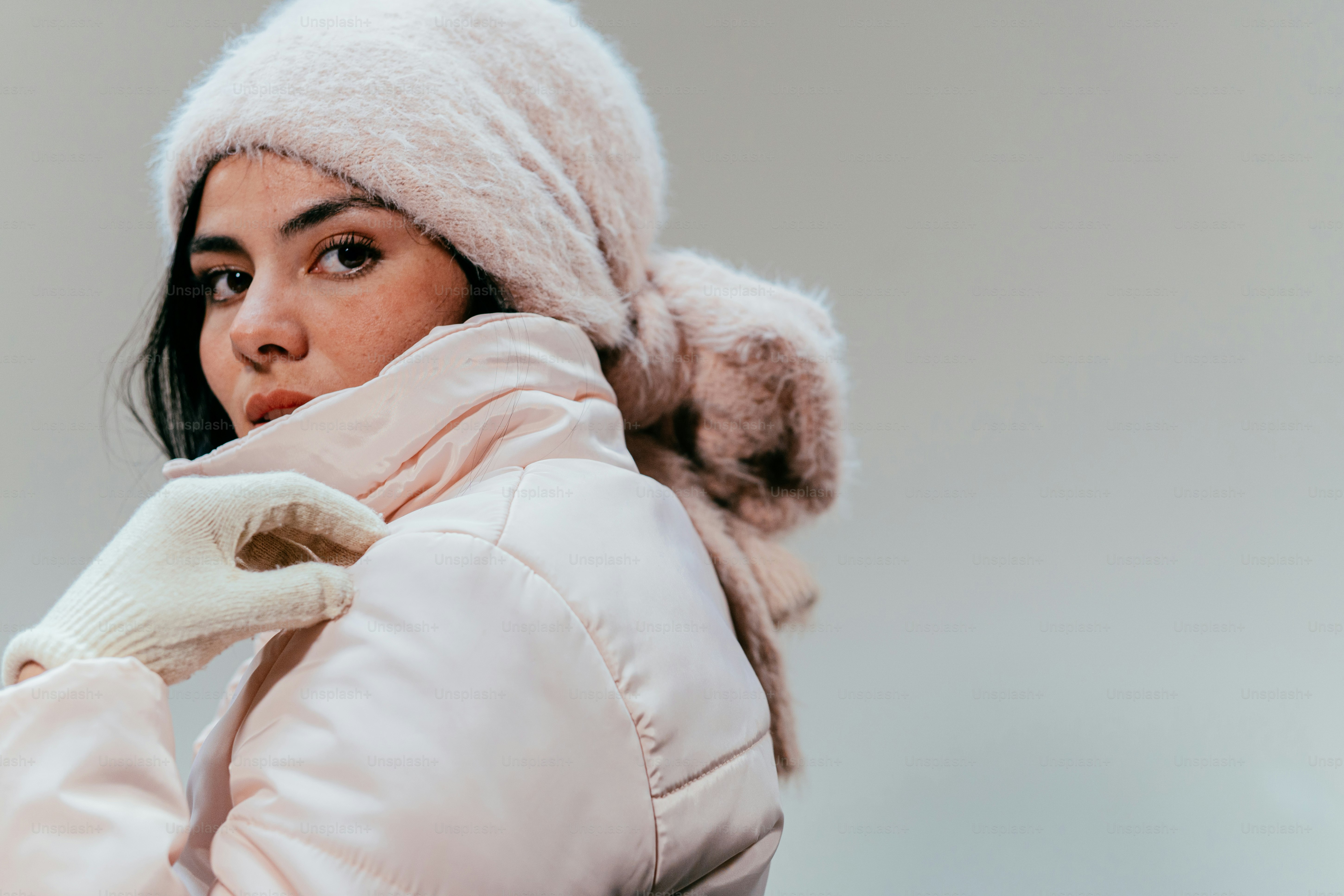 Young woman in pink winter hat and coat