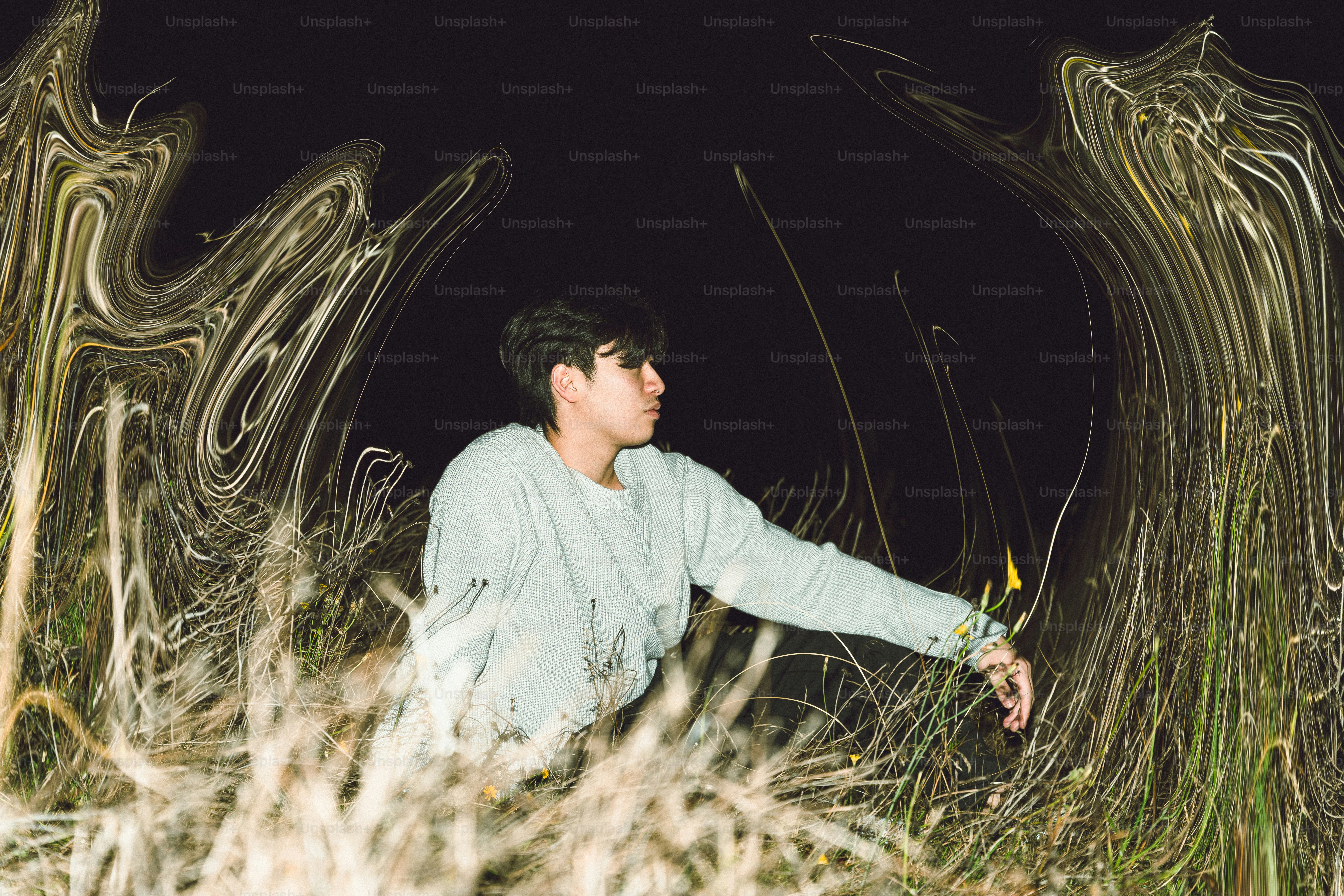 Man in a field at night with distorted surroundings.