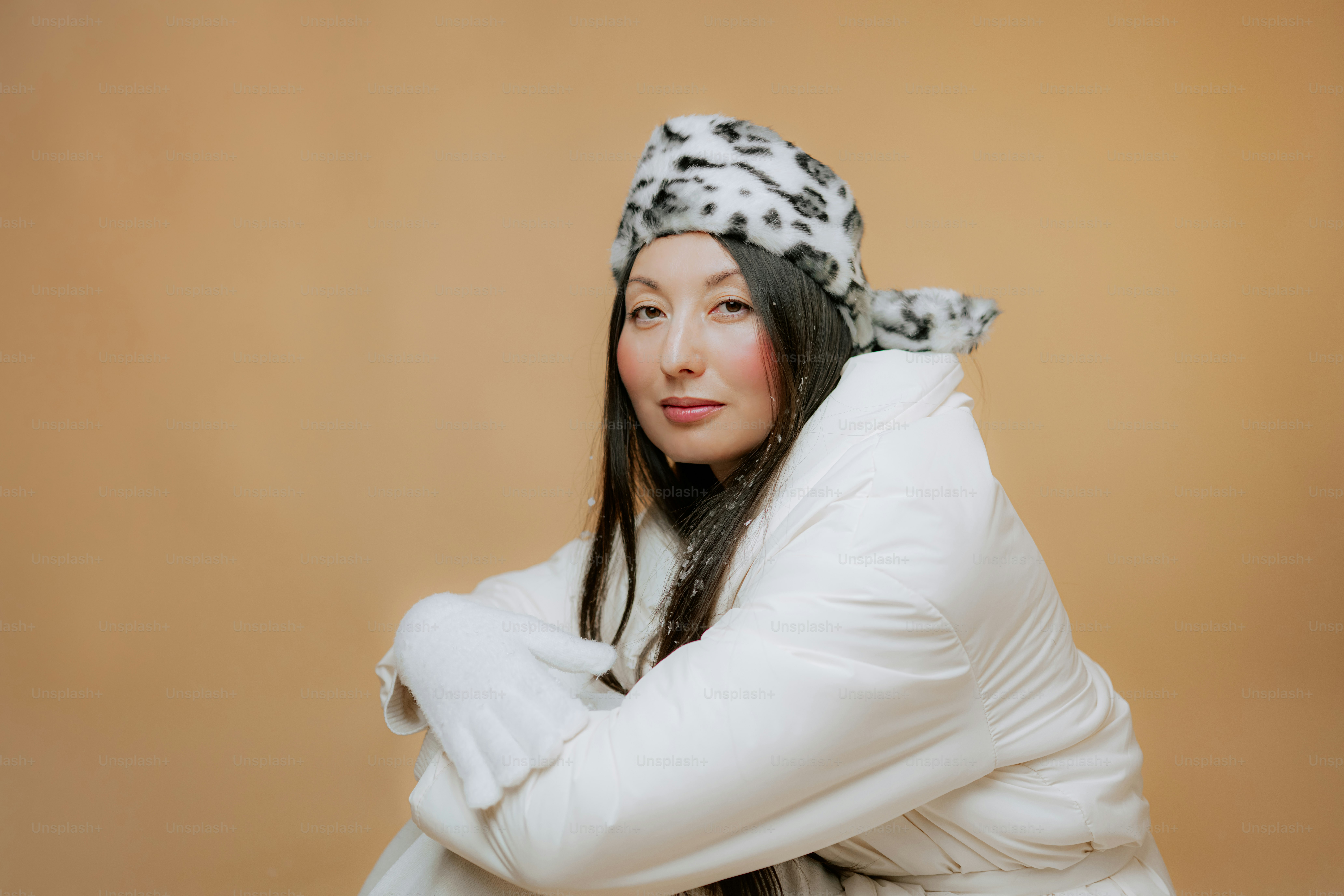 Woman in white winter coat and patterned hat