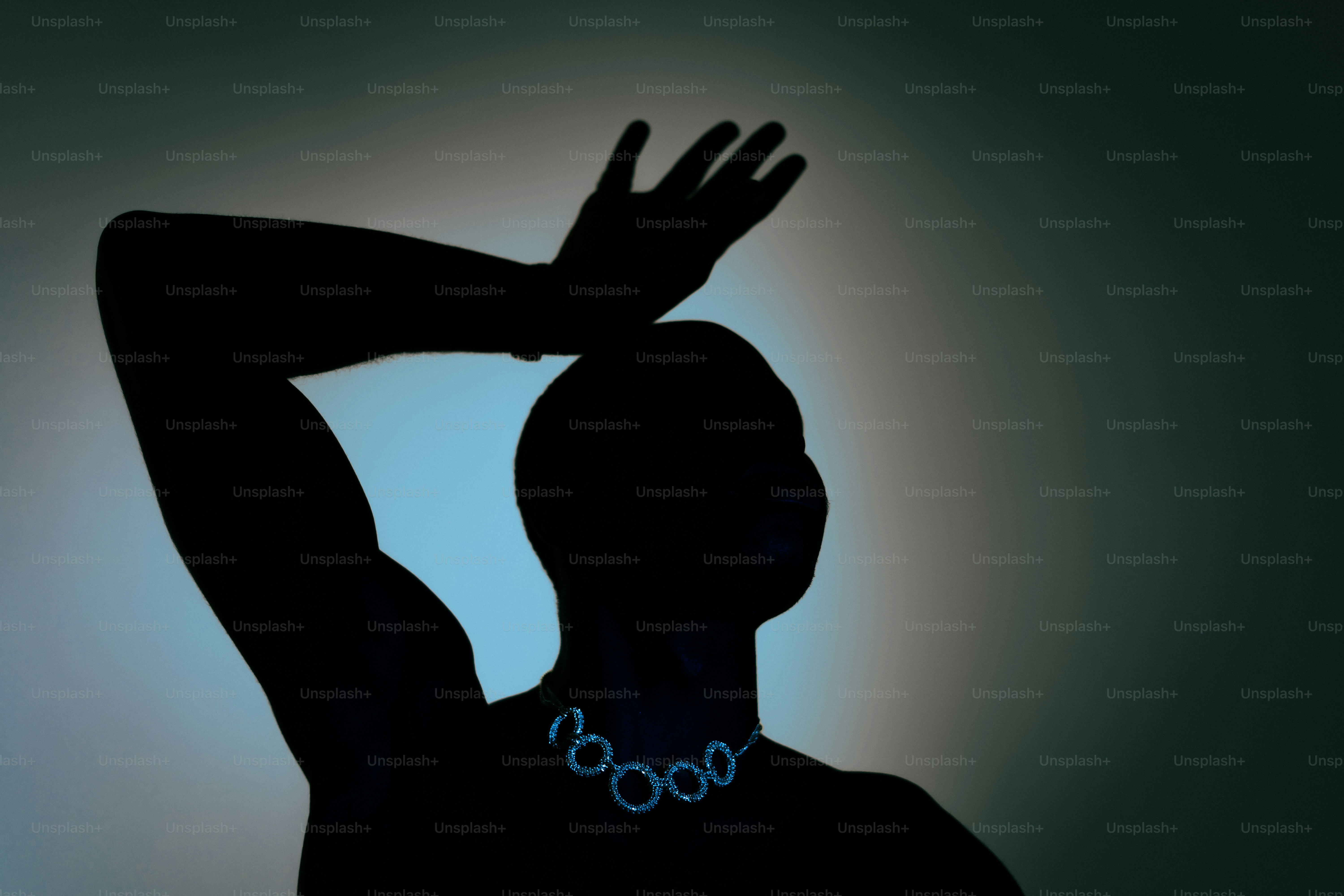 Silhouette of a person wearing a circular necklace