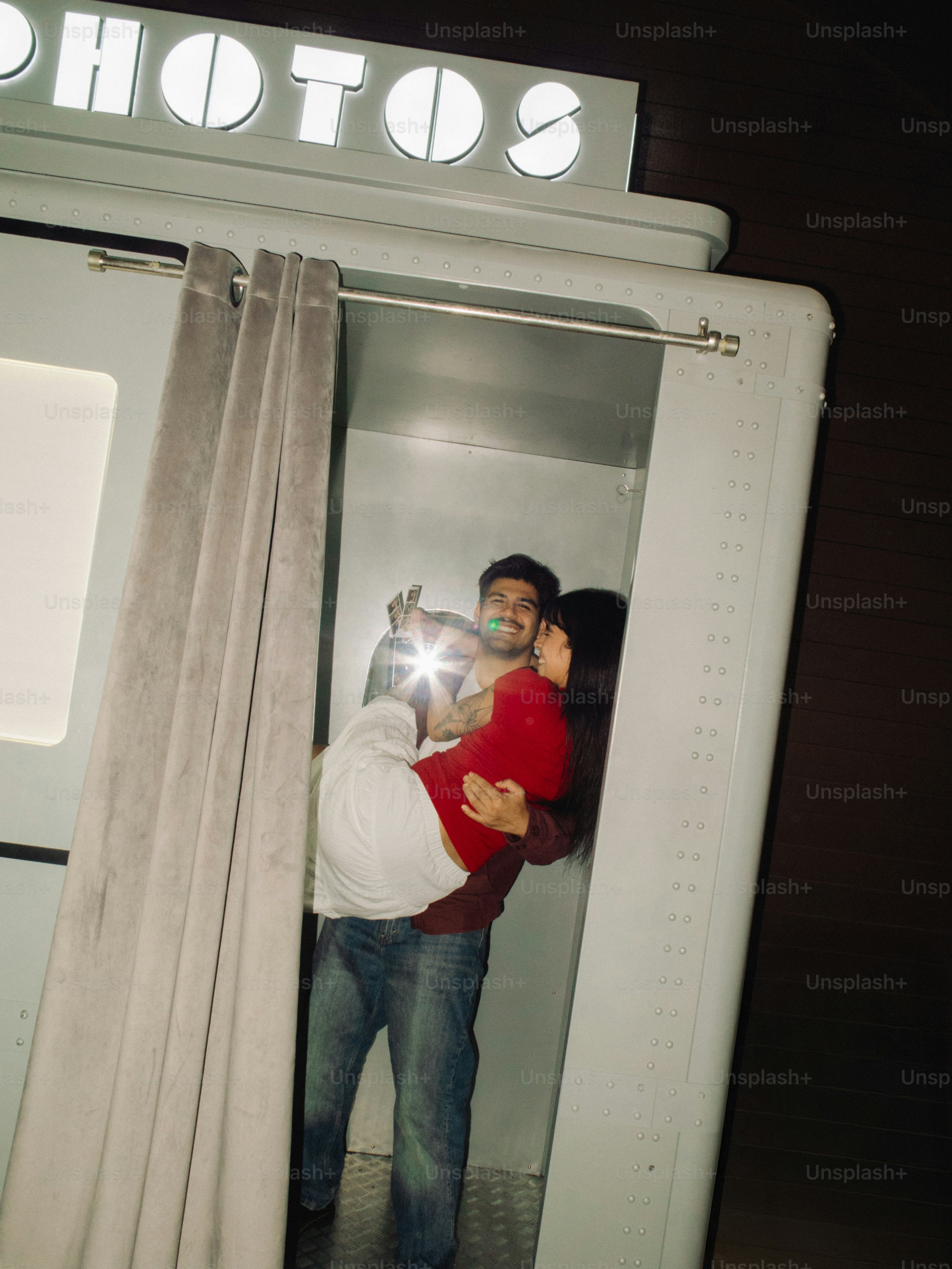 Couple taking a selfie in a photo booth