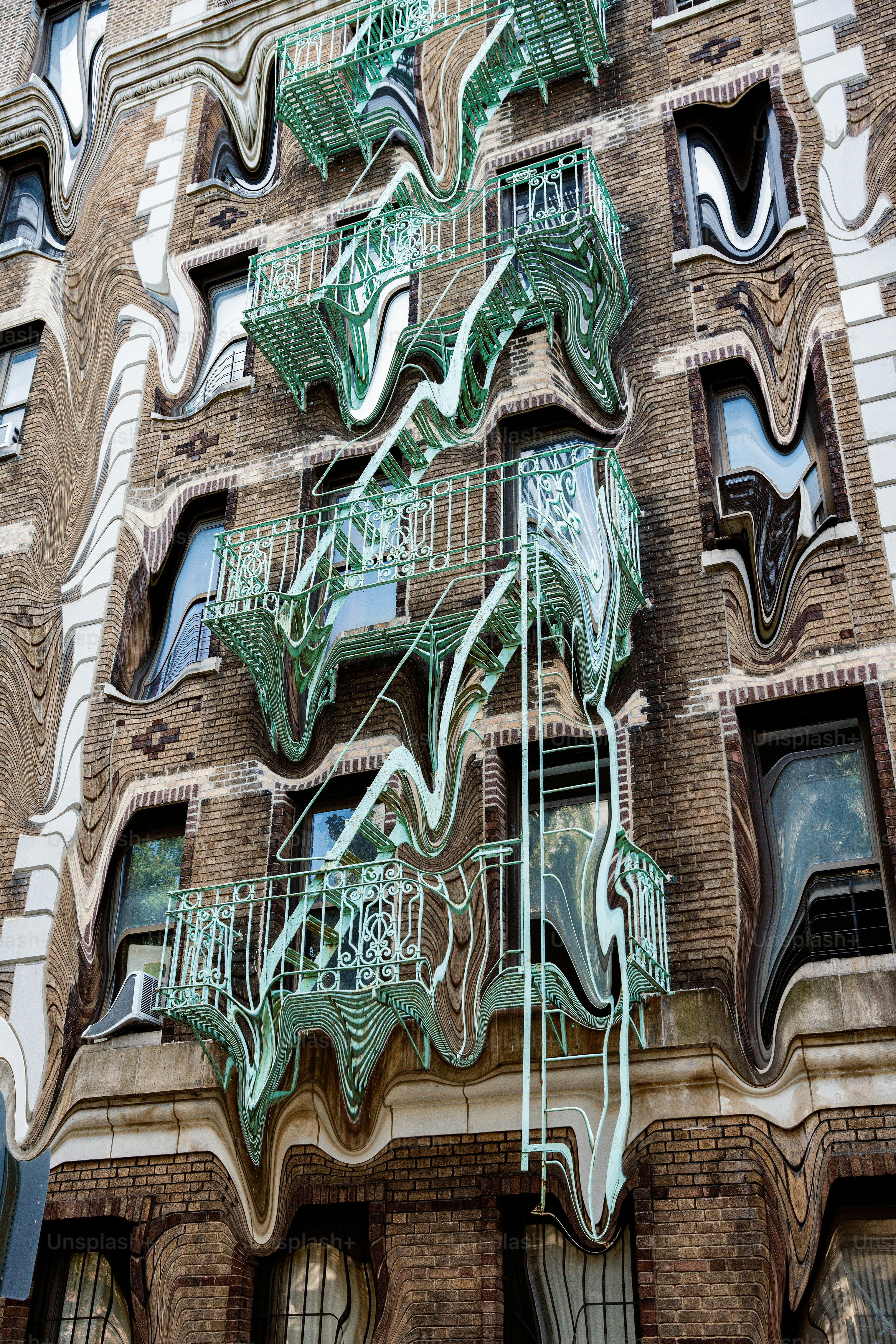 Distorted building facade with green fire escape
