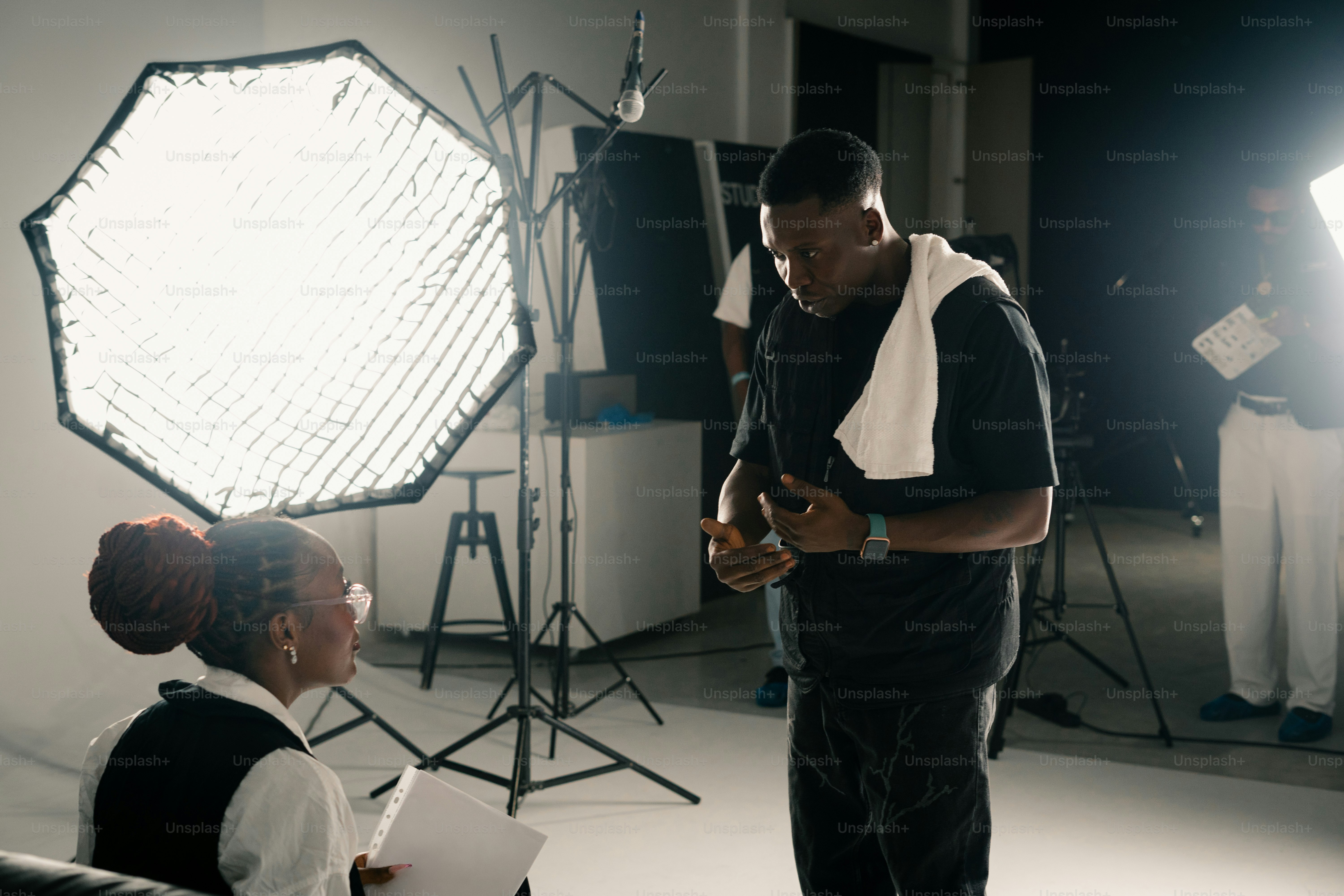 Two people in a studio with lighting equipment