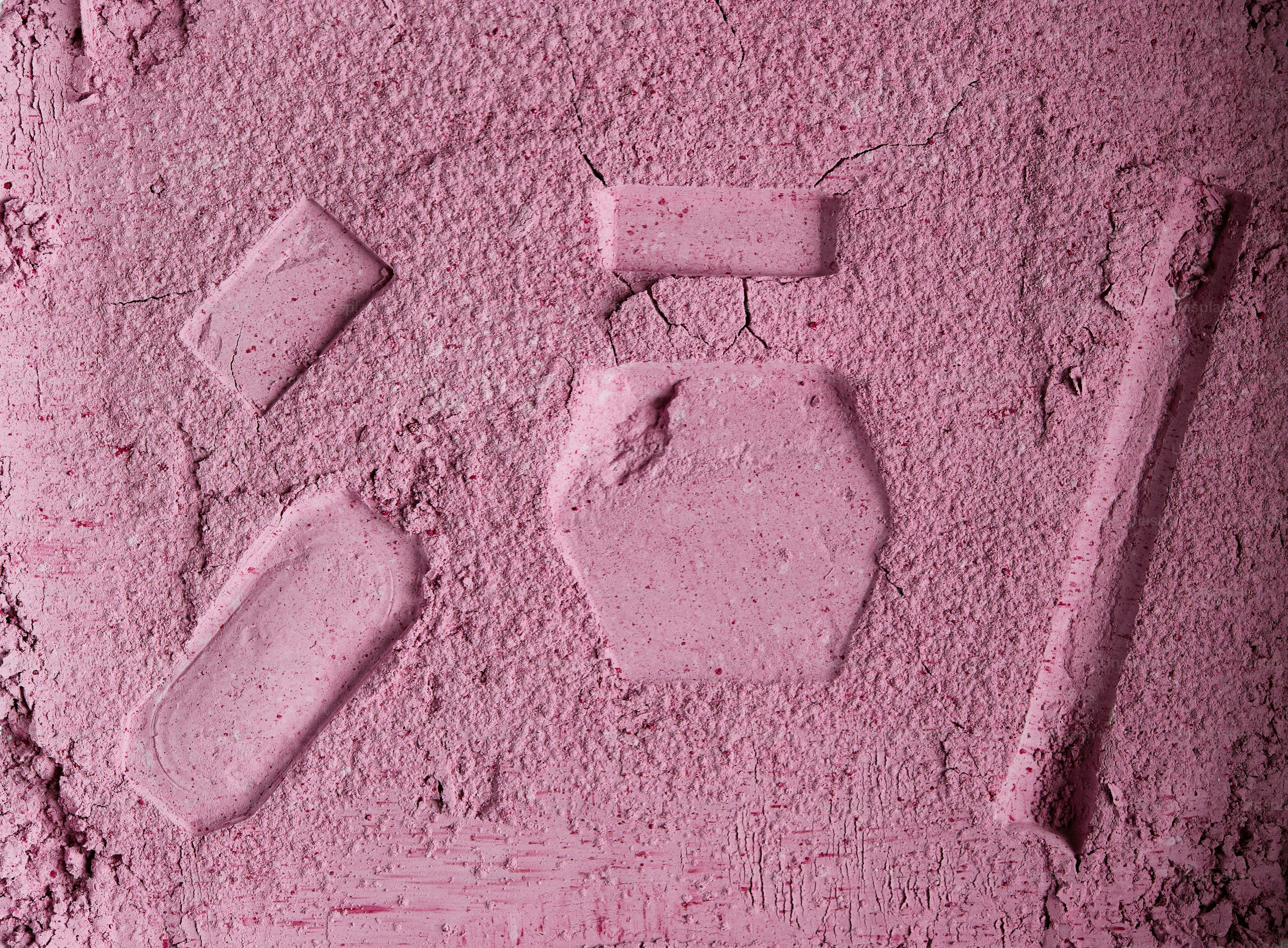 Pink powder with various geometric shapes pressed into it. photo ...