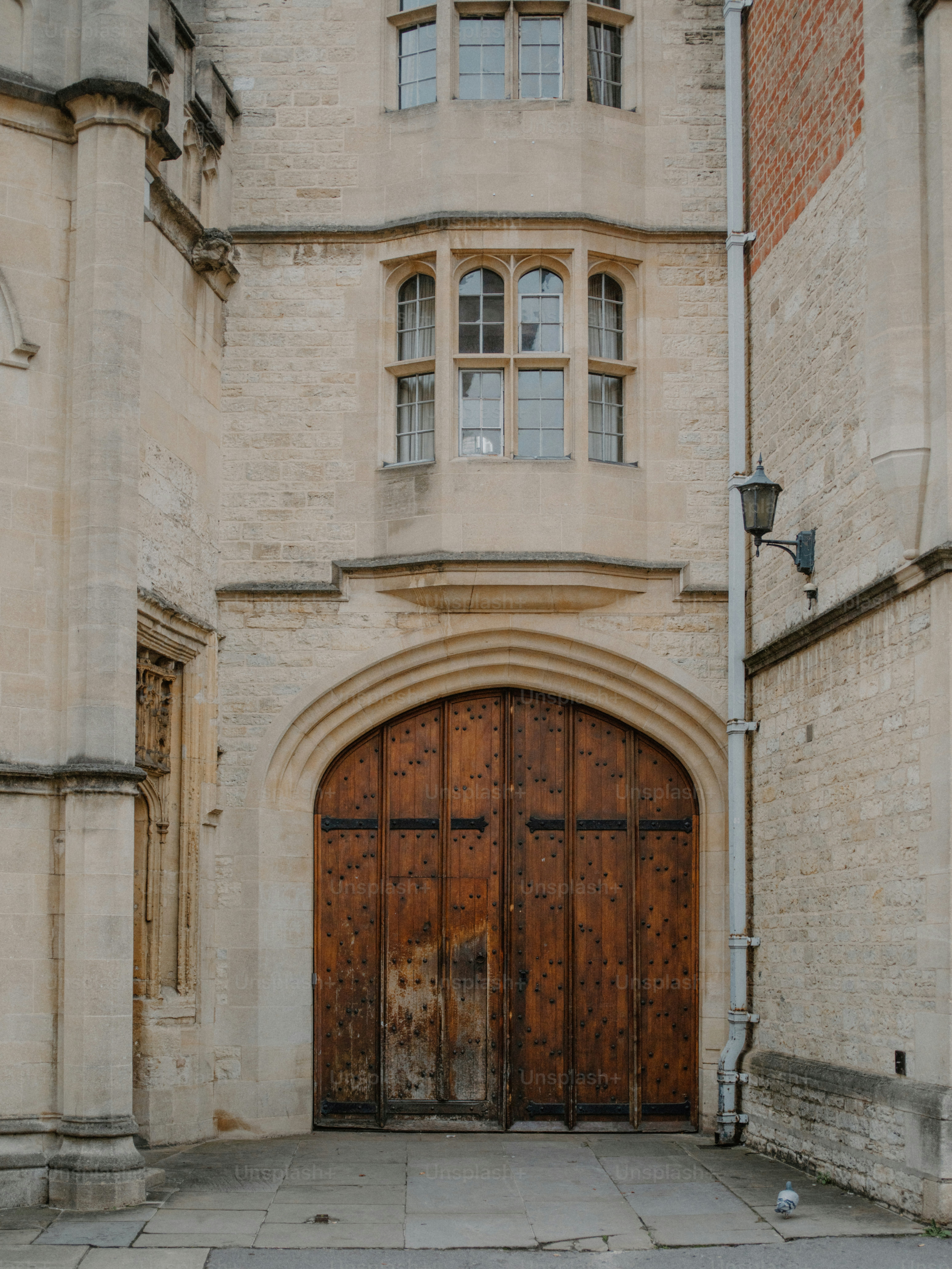 Large wooden doors beneath a stone arched entryway