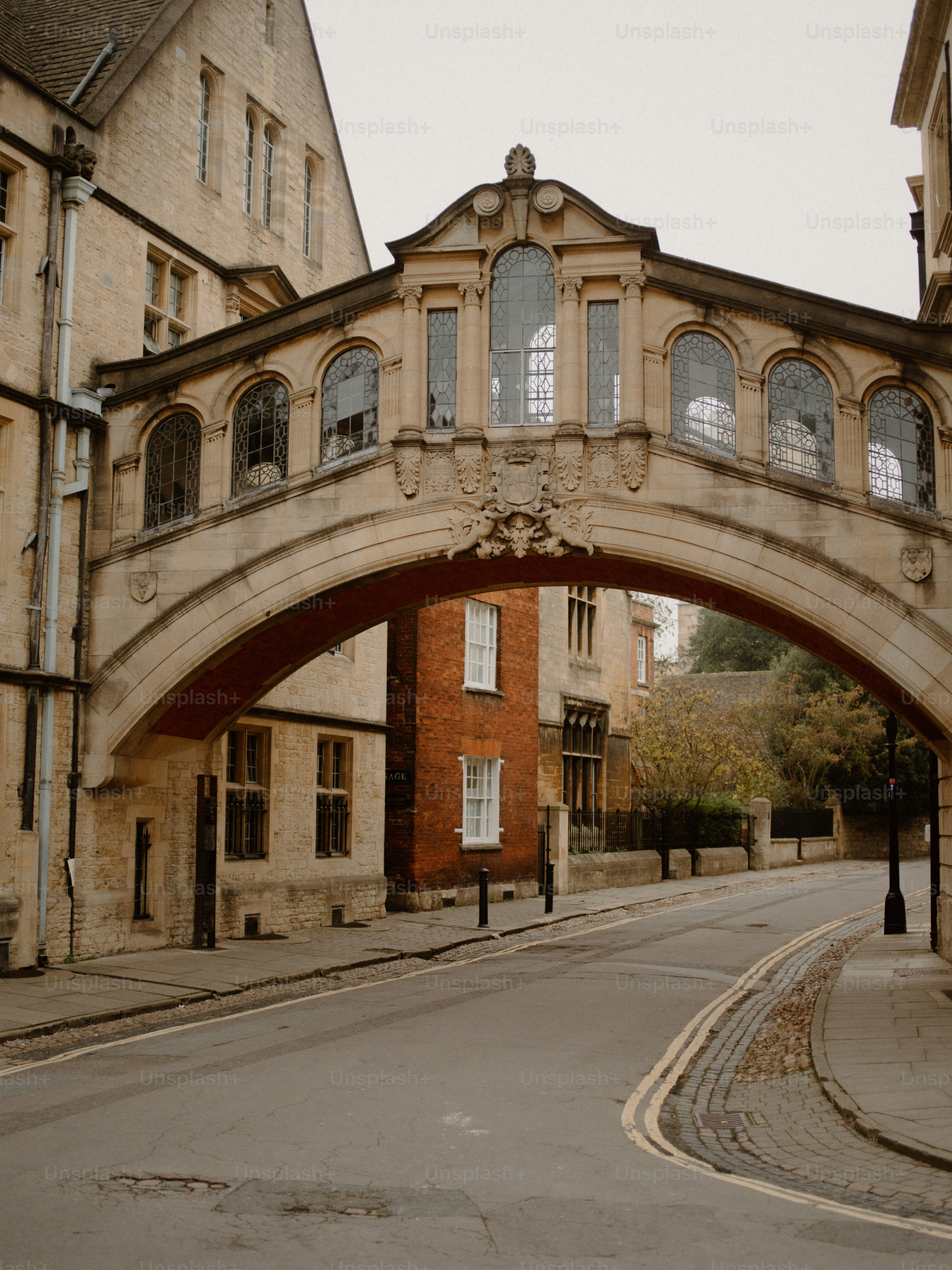 A stone bridge with arched windows over a street.